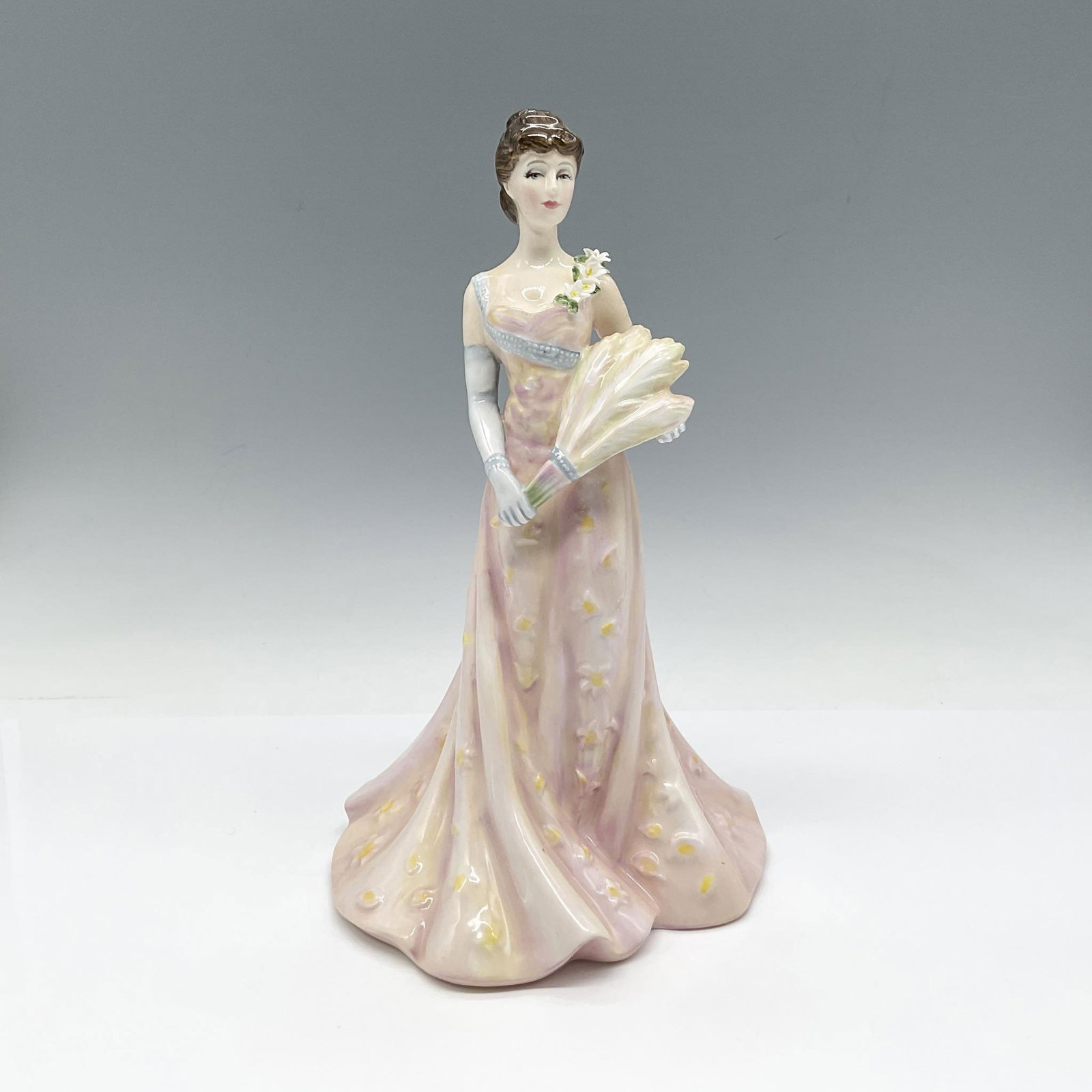 Lillie Langtry HN3820 - Royal Doulton Figurine: Limited Edition figure is part of the Edwardian and Victorian Actors series. Colored in pink with yellow and blue accents on her dress. Royal Doulton backstamp. Artist: Douglas V. Tootle Issued: c. 19