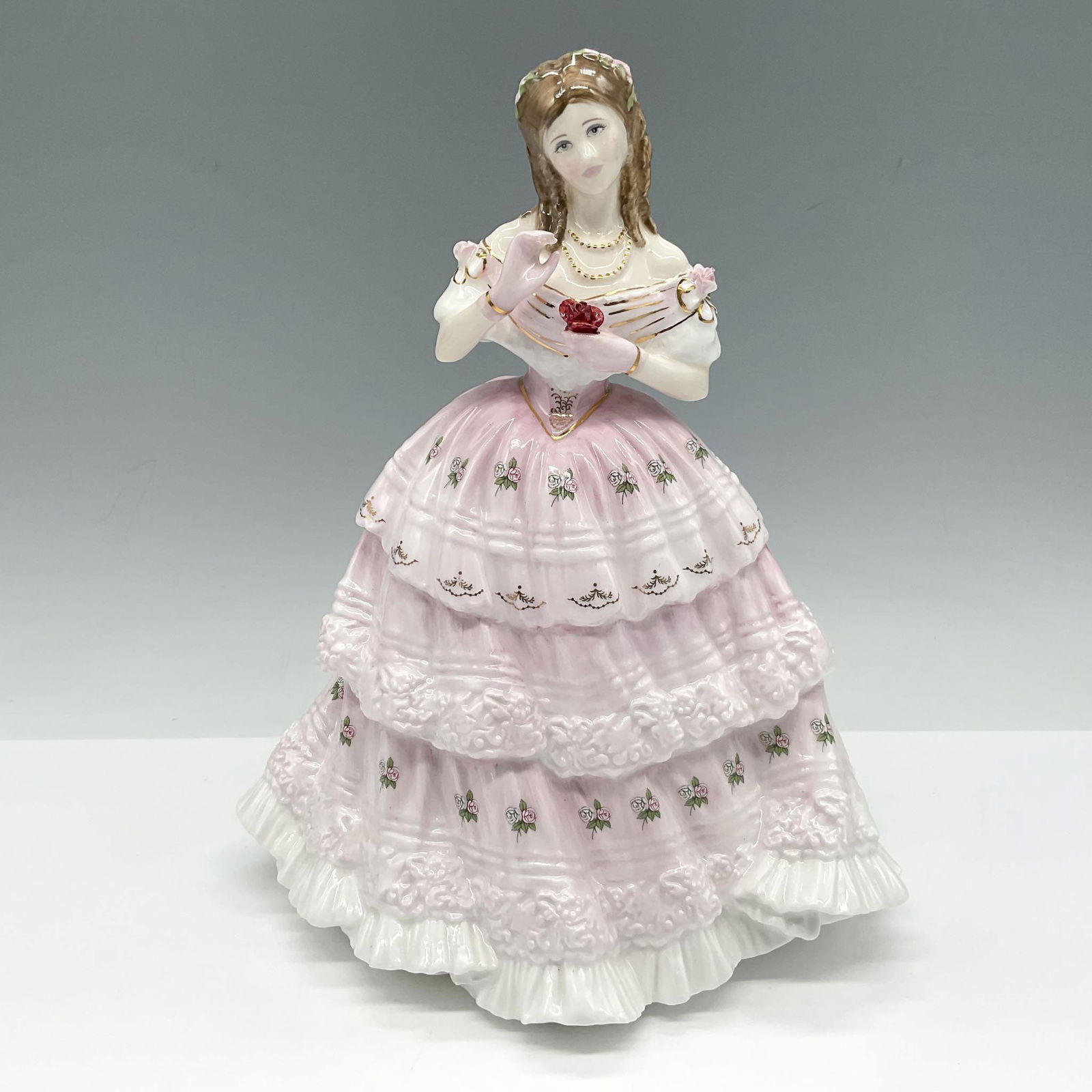 Red Red Rose HN3994 - Royal Doulton Figurine: Limited Edition figure is part of the Language of Love series, styled in pink and white with gilt accents. Royal Doulton backstamp. Artist: John Bromley Issued: c. 1997 Dimensions: 7"L x 6.5"W x 9"H E