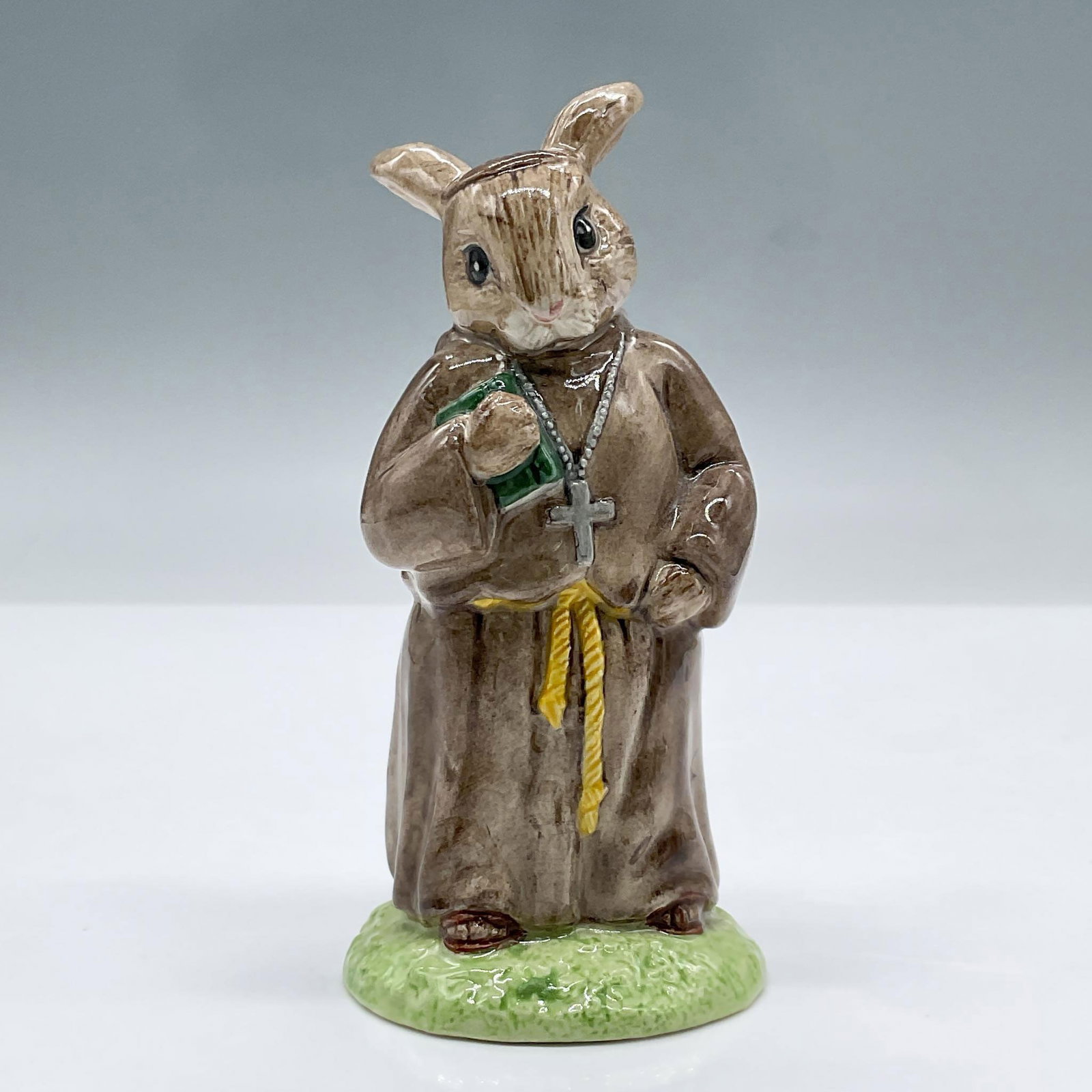 Friar Tuck DB246 - Royal Doulton Bunnykins: Modeled in brown and green colors. Royal Doulton backstamp. Artist: Martyn Alcock Issued: 2000 Dimensions: 4.5''H x 2''dia Manufacturer: Royal Doulton Country of Origin: England