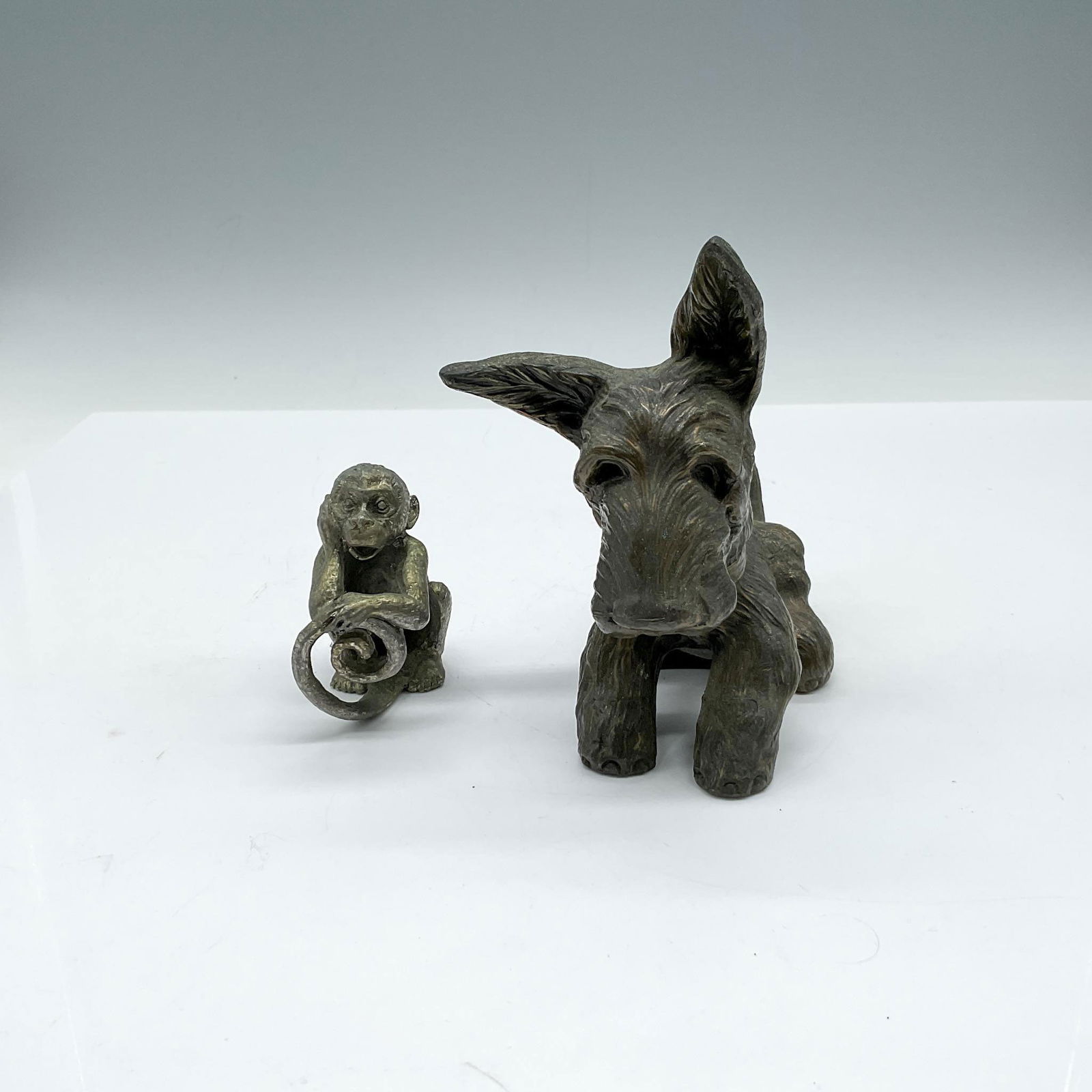 2pc Vintage Metal Animal Figurine and Paperweight: Lot includes monkey leaning on his tail - foot is signed by artist 2.25"L x 1.5"W x 3"H and Scotty dog figurine 4.75"L x 2.75"W x 5"H. Issued: 20th century Dimensions: See Description