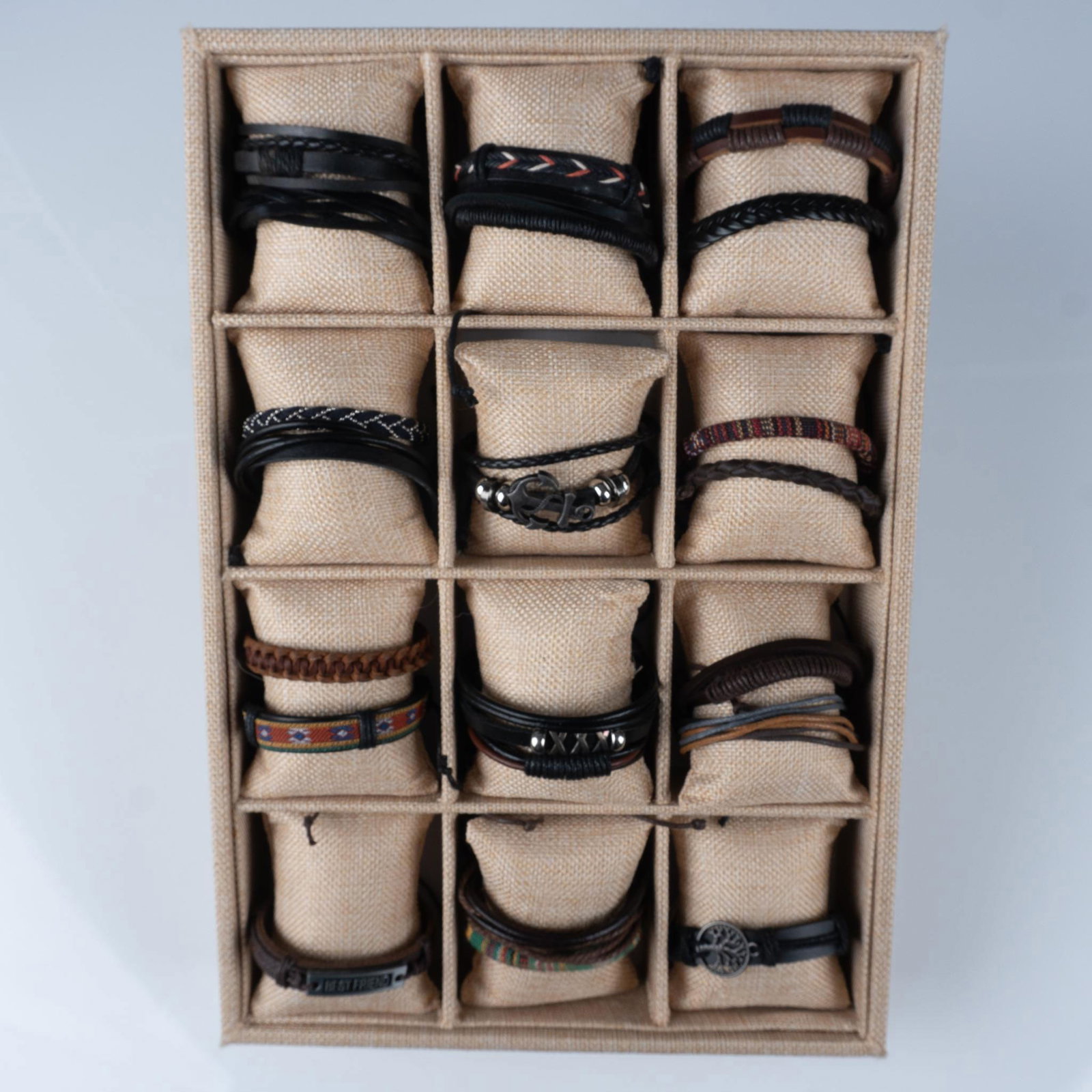 22pc Men's Leather Bracelets with Display Tray: This collection of bracelets features a rugged and versatile assortment of leather and woven designs. The set includes braided leather bands, minimalist black straps, colorful woven accents, and piece