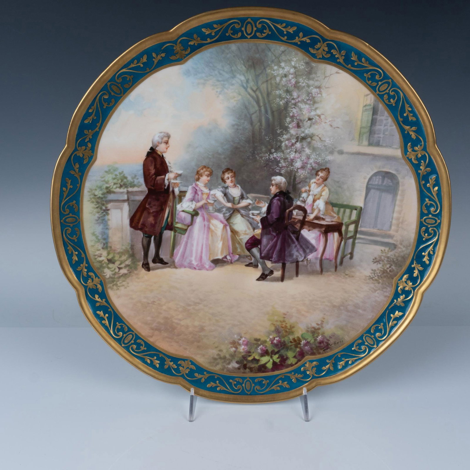 L.S. & S. Limoges Porcelain Charger: Hand painted Victorian scene of grouping gathered in a patio. Gilt and turquois rim surrounds center art. L.S.& S. Limoges France backstamp. Issued: 20th century Dimensions: 2"H x 16" dia. Manufacture