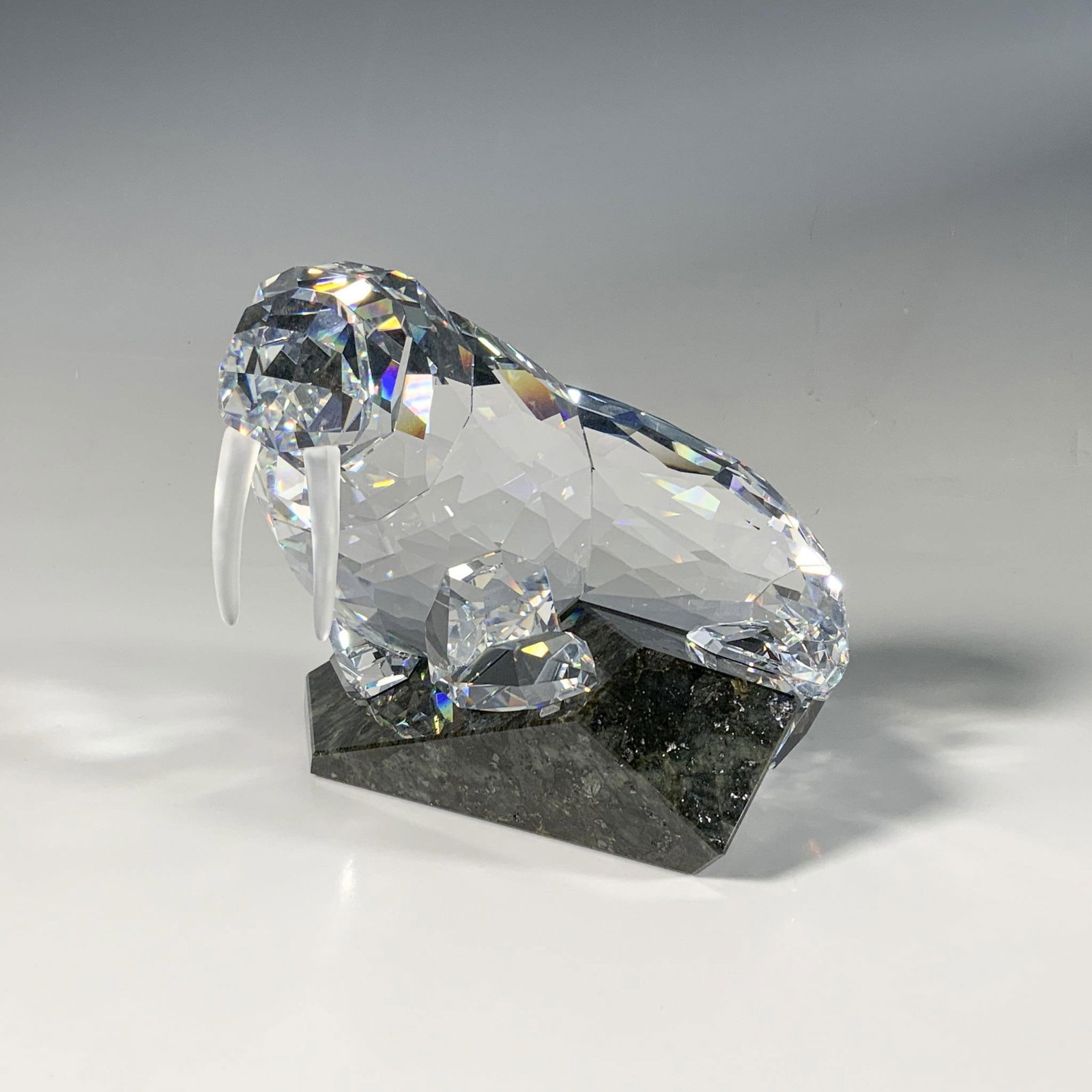 Swarovski Crystal Figurine, Soulmates Walrus: An impressive, large, faceted figure of a walrus, featuring smooth frosted tusks, naturally posed on a cut emerald pearl granite base. Part of the Soulmates collection. Swarovski marking. This item ha