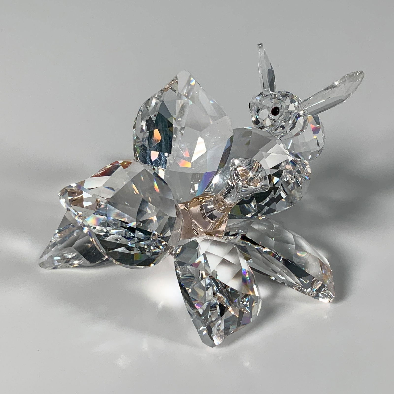 Swarovski Crystal Figurine, The Collector, Bee on Flower: This stunning clear faceted figure features a small bee perched on a beautiful flower with a light peach crystal stamen. It was created to celebrate the 20th anniversary of SCS in 2007. Swarovski mark