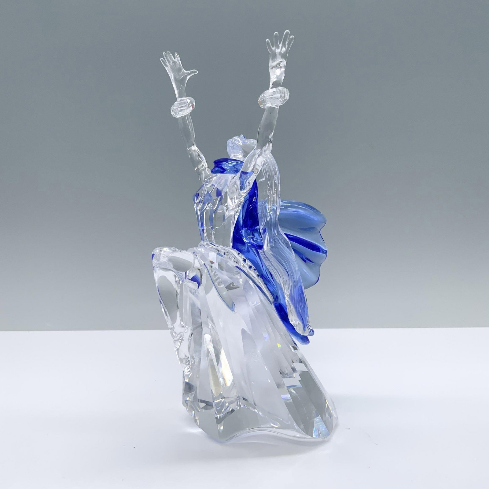 Swarovski Crystal Society Figurine, Isadora: Annual edition lead crystal first edition of the Magic of Dance trilogy. Isadora is depicted in clear and blue crystal with moveable bracelets on her wrists. Swarovski Swan backstamp. This item has it