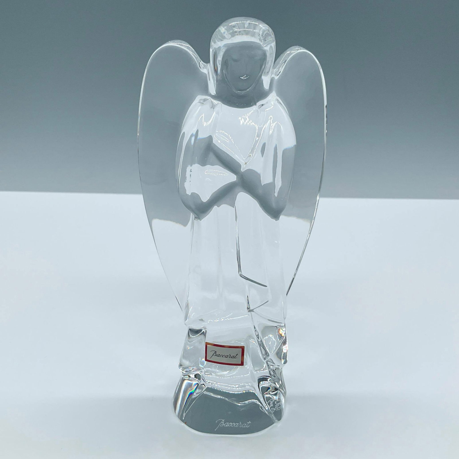 Baccarat Crystal Figurine, Angel: Beautiful thick clear crystal figure of an Angel. Baccarat engraved signature, backstamp and tag. Issued: 20th century Dimensions: 3''L x 2''W x 6.25''H Manufacturer: Baccarat Country of Origin: Franc
