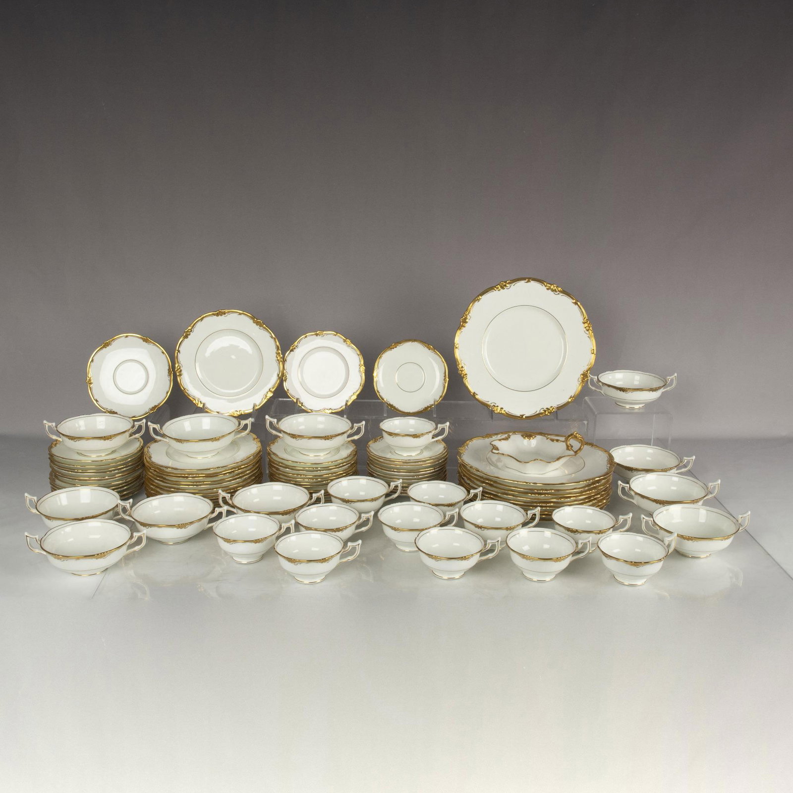 82pc Coalport Bone China Dinner Service, Eden Pattern: Coalport's discontinued Eden pattern can be identified by its thick gold scalloped trim on a solid white plate. This lot includes 10 dinner plates measuring 0.75"H x 10.5"dia., 12 salad plates measuri