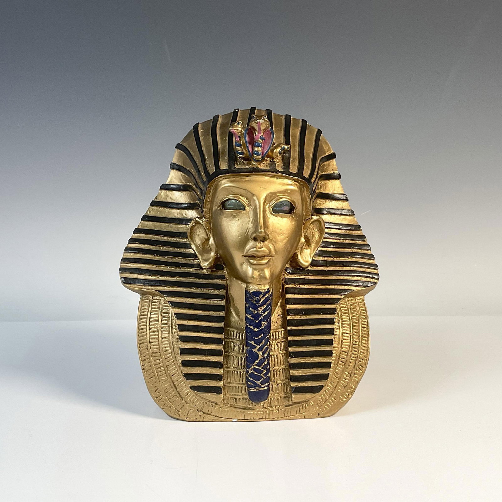 King Tut Bust with Crystal Eyes and Candle Holder: Unique bust of the Egyptian Pharoah King Tut. His eyes are clear glass and behind his head is a spot to hold a candle. Bust is hefty and painted. Dimensions: 8.5"L x 6.5"W x 10"H