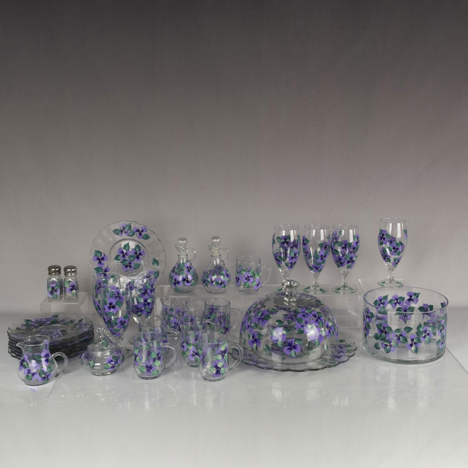 32pc Hand Painted Glass Dinner Service, Purple Pansies: Charming set of clear glass dishes decorated with hand painted lavender pansies. Most pieces are signed and dated by the artist. This lot includes 8 plates measuring 1"H x 9"dia., 8 mugs measuring 4.5
