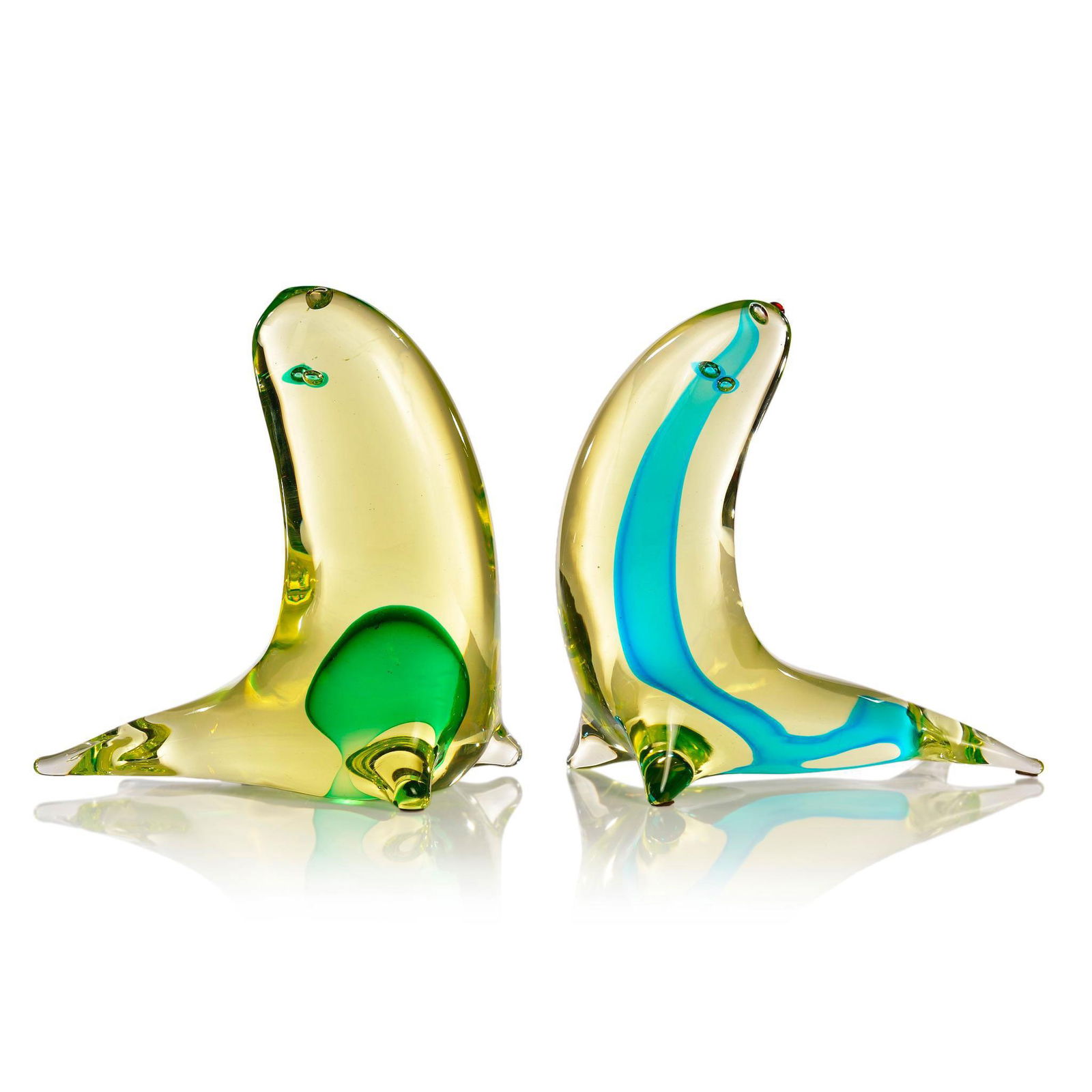 Pair of Cenedese Murano Glass by Antonio Da Ros Sculptures: Designed by Antonio Da Ros (Italian. 1936-2012) 2 seals in yellow transparent glass. Each with a green ball and a long line submerged within the body. Air bubble to design the eyes and a red nose. Bot