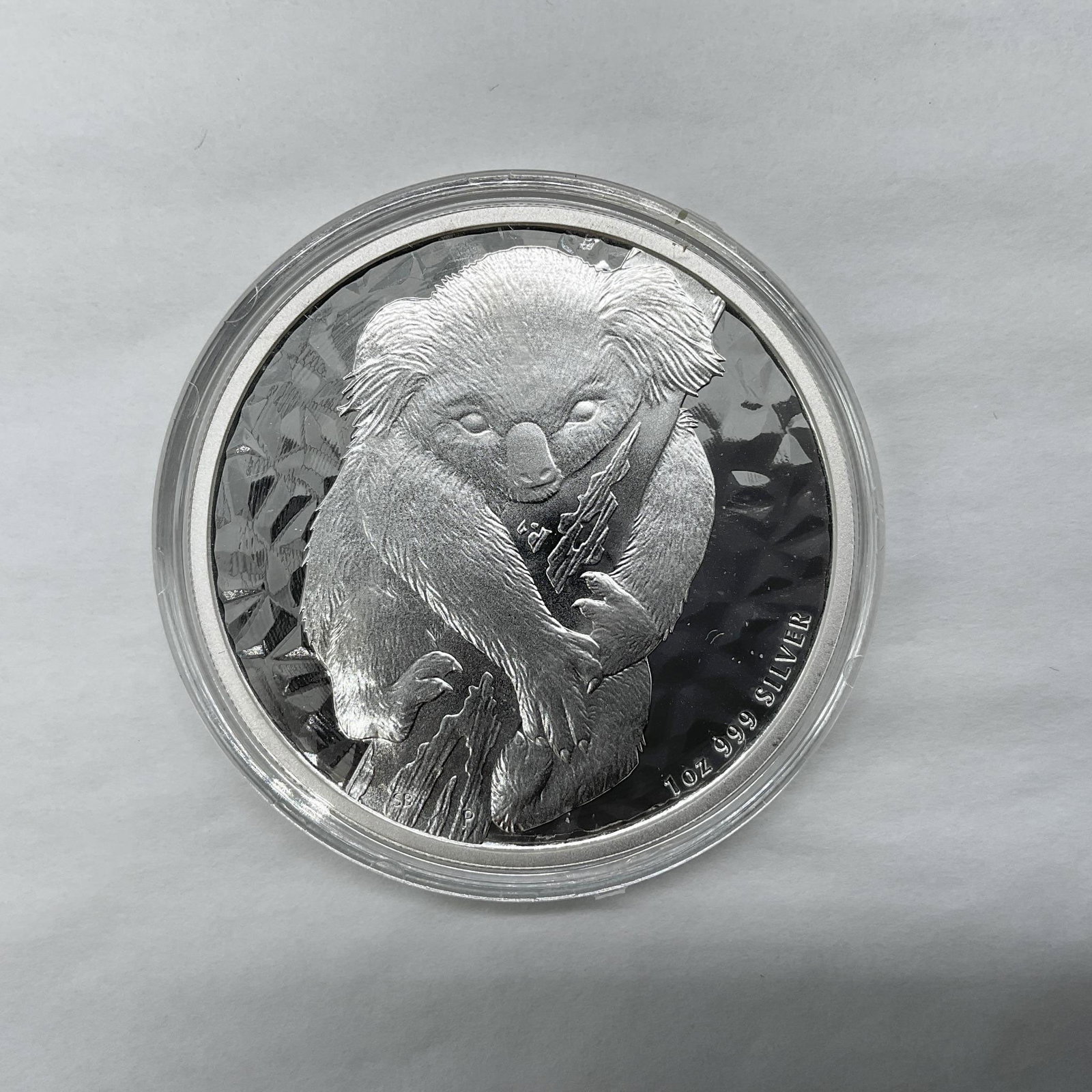 2007-P Australia Elizabeth II - Koala 1oz Silver Coin: Perth Mint. The obverse side features Queen Elizabeth II facing right wearing the Girls of Great Britain and Ireland Tiara. The reverse side depicts a koala clinging to a tree branch with a shimmer ba