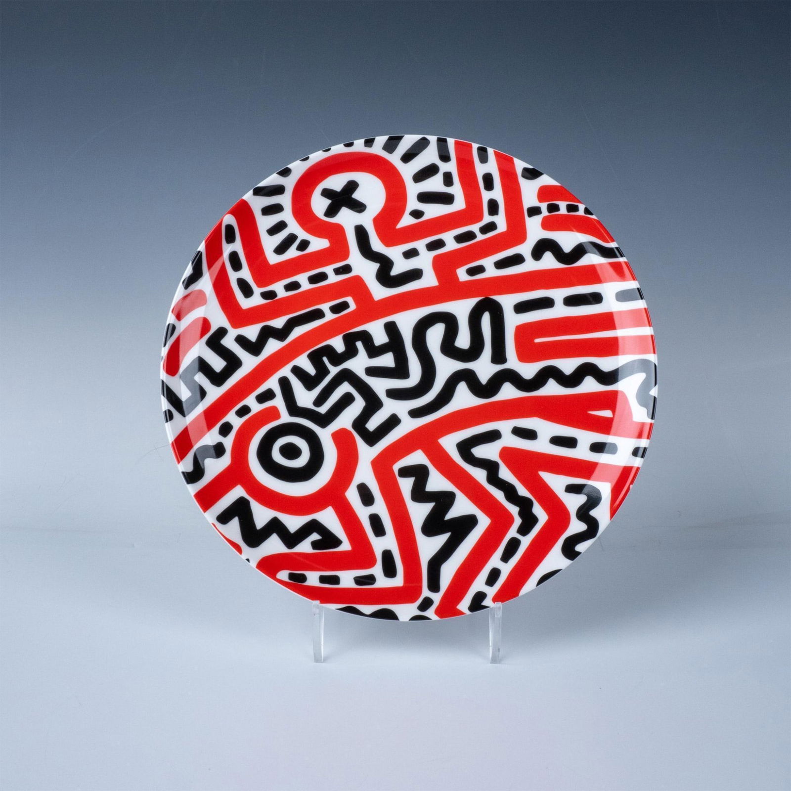 After Keith Haring (American b. 1958) Plate, Untitled: Fine bone china plate designed with black and red outlines and geometric shapes. Part of The 2021 Artist Plate Project to benefit the Coalition for the Homeless, with permission from the Keith Haring