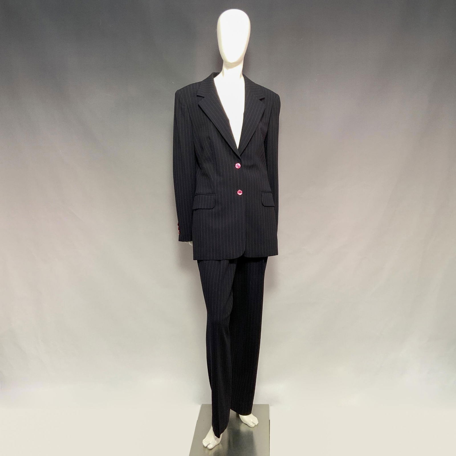 3pc Escada Margaretha Ley Stripped Wool Pantsuit & Skirt Set: Crafted in black fabric with delicate pink stripes. Includes a tailored blazer with shoulder pads, two faux front pockets, functional front buttons, and decorative buttons on the sleeves. Beautifully