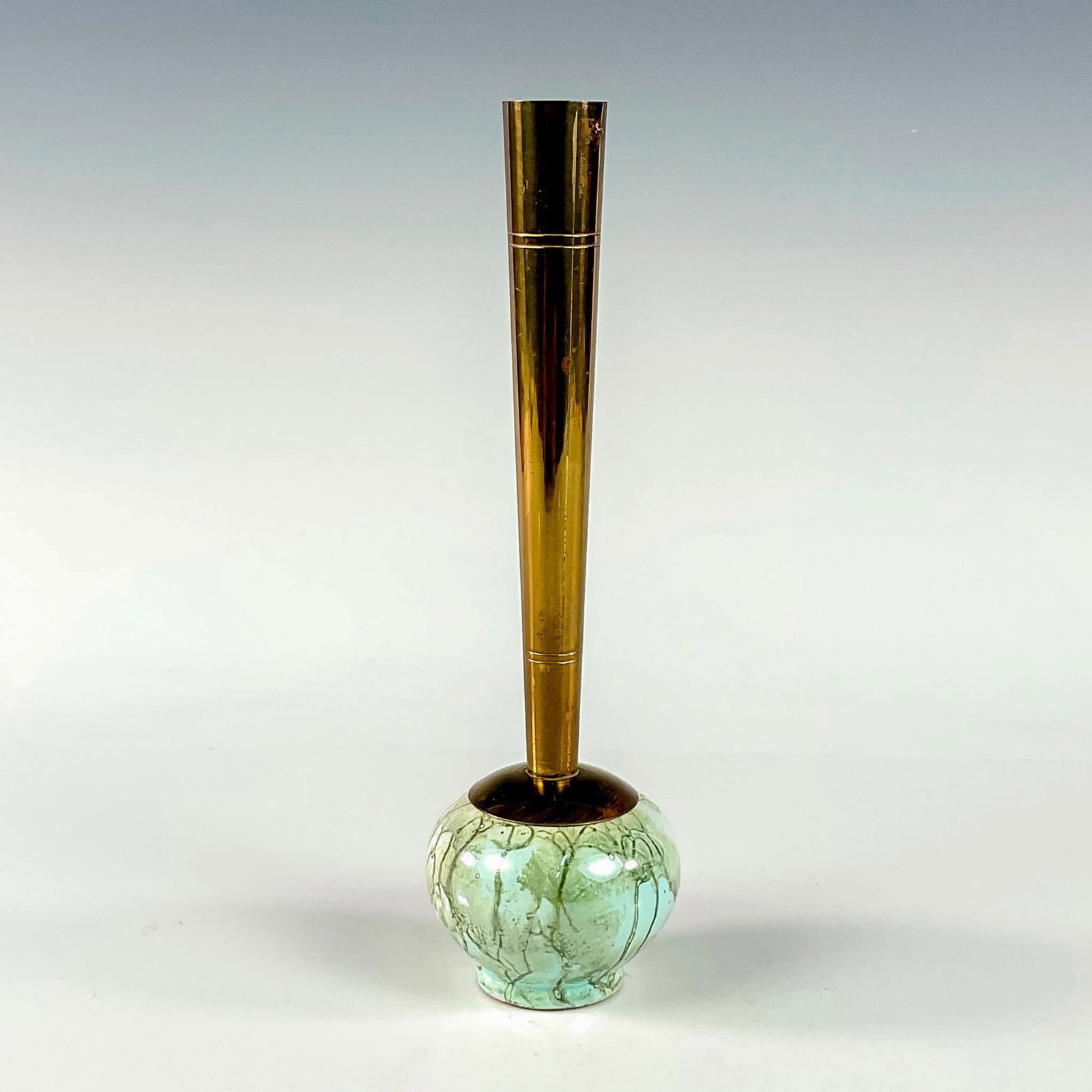 Delft Mid-Century Modern Lustre Glaze Bud Vase: Turquoise with lustre finish and branch patterning. Round body. Narrow brass spout. Hand Painted Delft Holland on bottom. This item has no reserve. Dimensions: 2.25"W x 8"H Manufacturer: Delft Country
