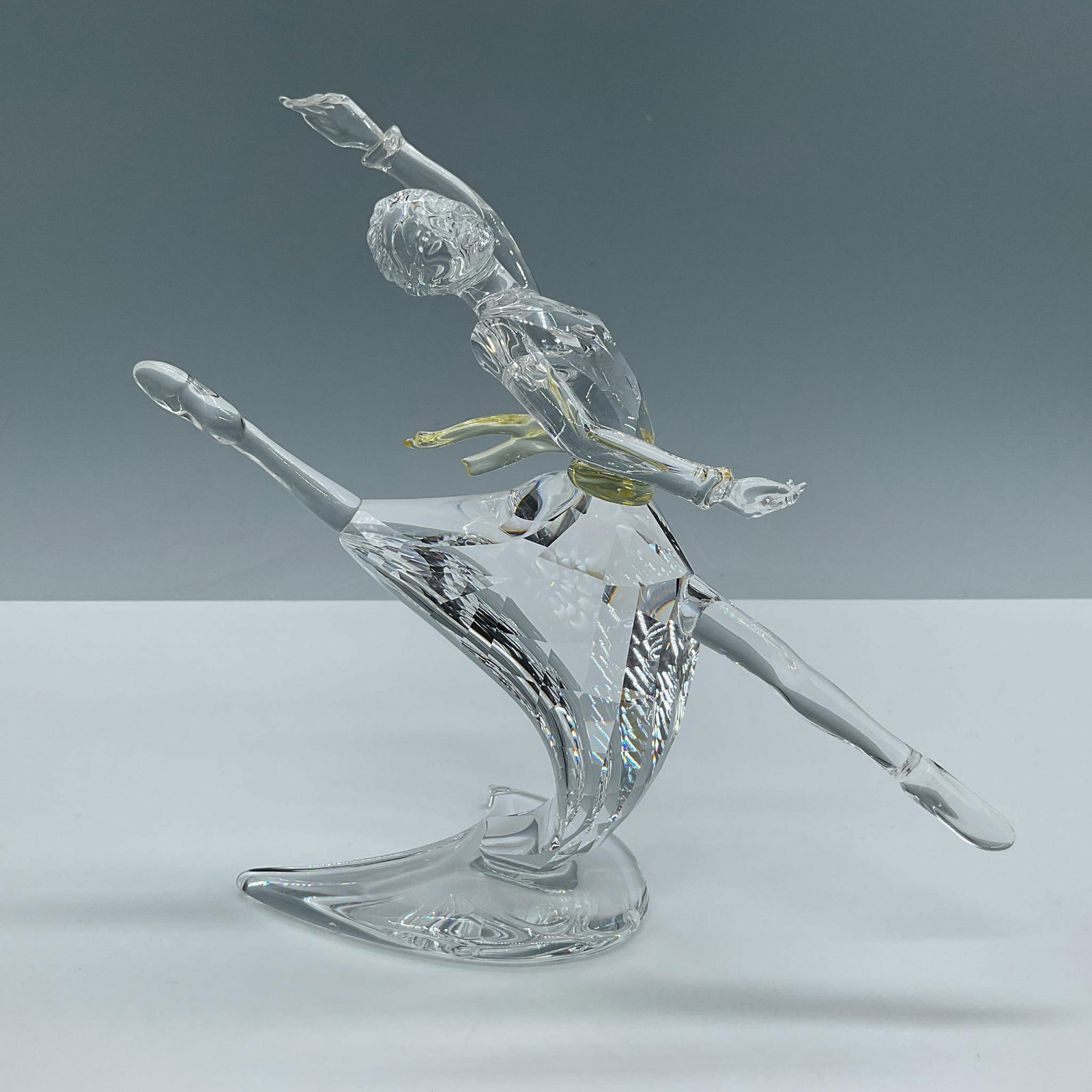 Swarovski Crystal Figurine, Magic of Dance Anna: Anna was designed to represent the famous ballerina Anna Pavlova and is made from clear and yellow crystals. From the Magic of Dance Trilogy. This item has its original box which measures 9.75''L x 9.