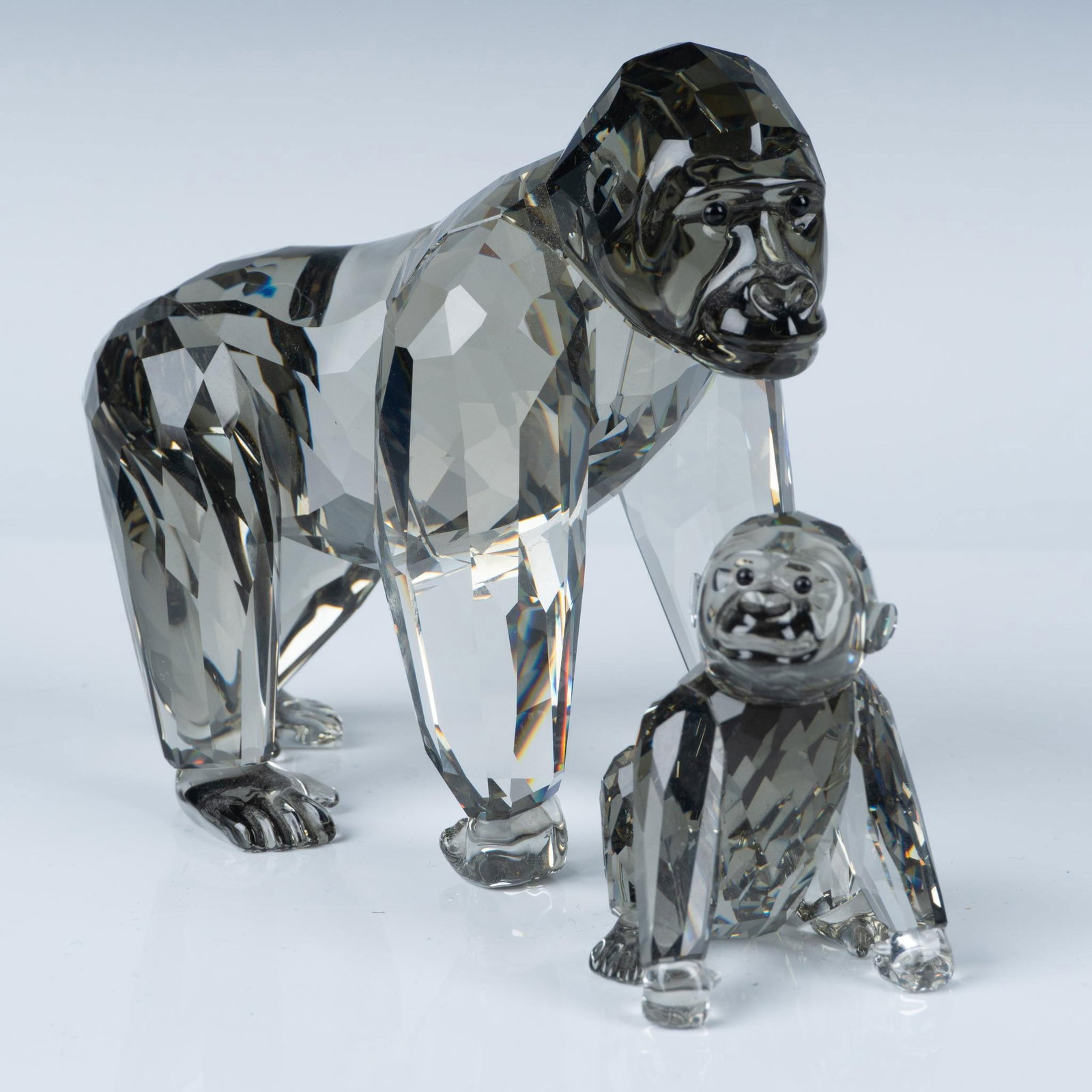 Swarovski Crystal 2009 SCS Figurines, Gorillas: This dynamic duo is crafted from black crystal and features black eyes. From the Endangered Wildlife series. SCS 2009 Annual Edition. Swarovski acid mark. Largest figurine: 5"L x 2.5"W x 4.25"H. This 