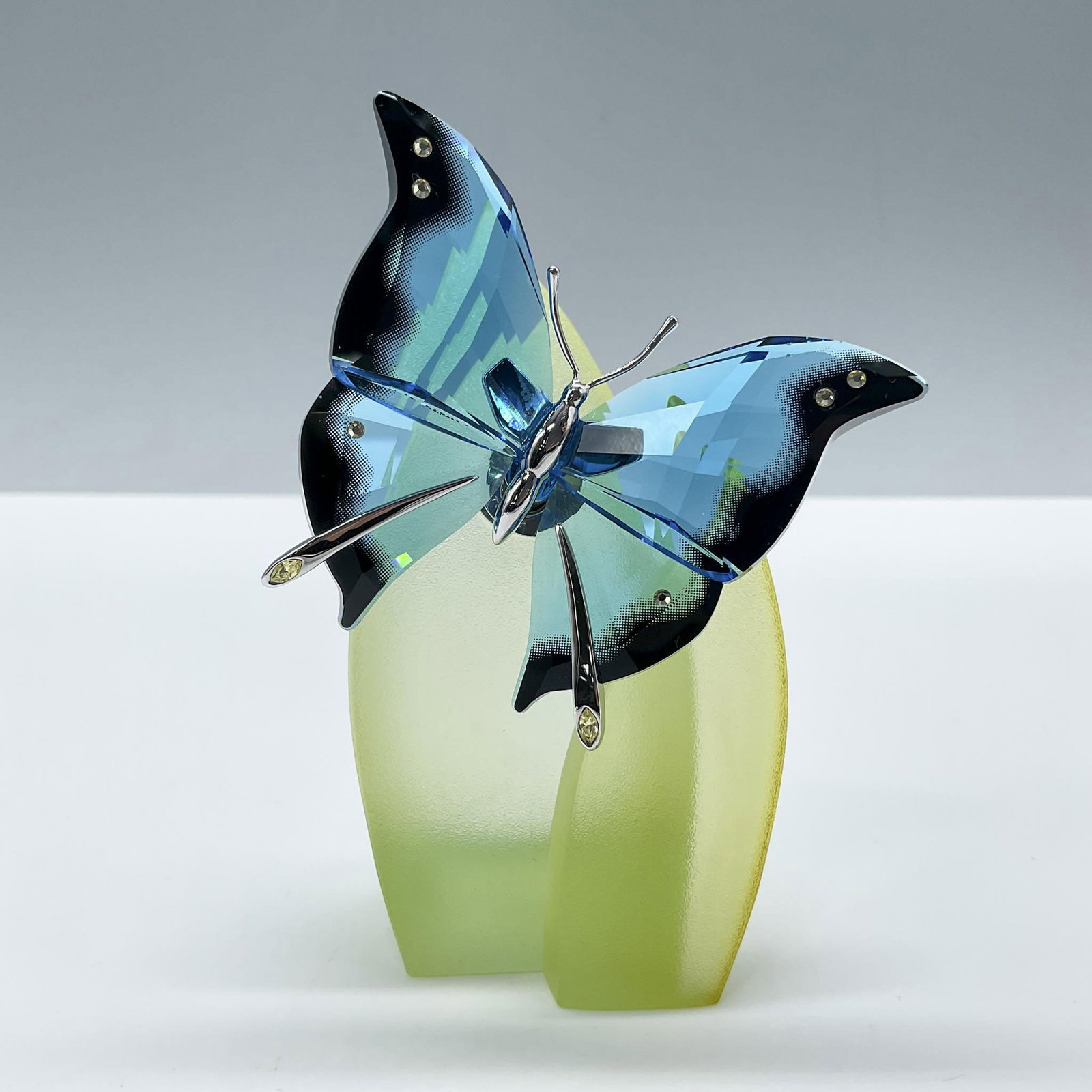 Swarovski Crystal Figurine, Butterfly Ambur Turquoise-Color: A turquoise-colored butterfly was part of the Exotic Butterflies collection, with faded black edging, and crystal point details, on a green acrylic 2-piece stand. Swarovski backstamp. Artist: Roland S