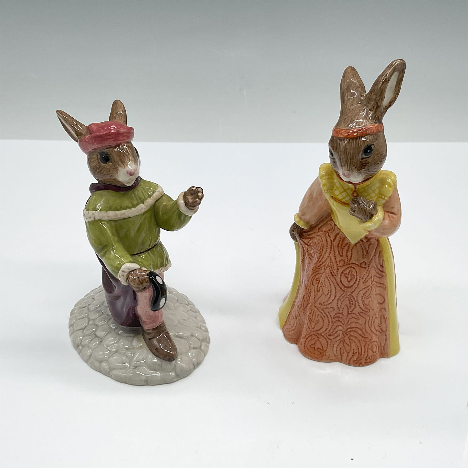 2pc Royal Doulton Bunnykins Romeo and Juliet Figurines: Pair of Royal Doulton Bunnykins figurines, featuring Romeo Bunnykins (DB 284) and Juliet Bunnykins (DB 283). These hand-made and hand-decorated porcelain figurines were crafted exclusively for the Roy