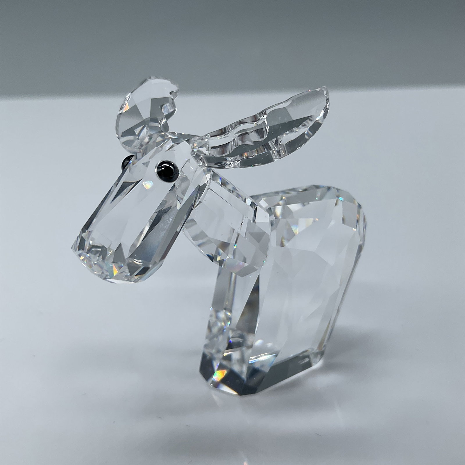 Swarovski Crystal Figurine, Lovlots Ricci Moose: Swarovski crystal figurine "Ricci the Moose" from the retired Lovlots Pioneers collection, designed by Edith Mair. This delightful collectible stands 2"H and features intricate clear crystal craftsman