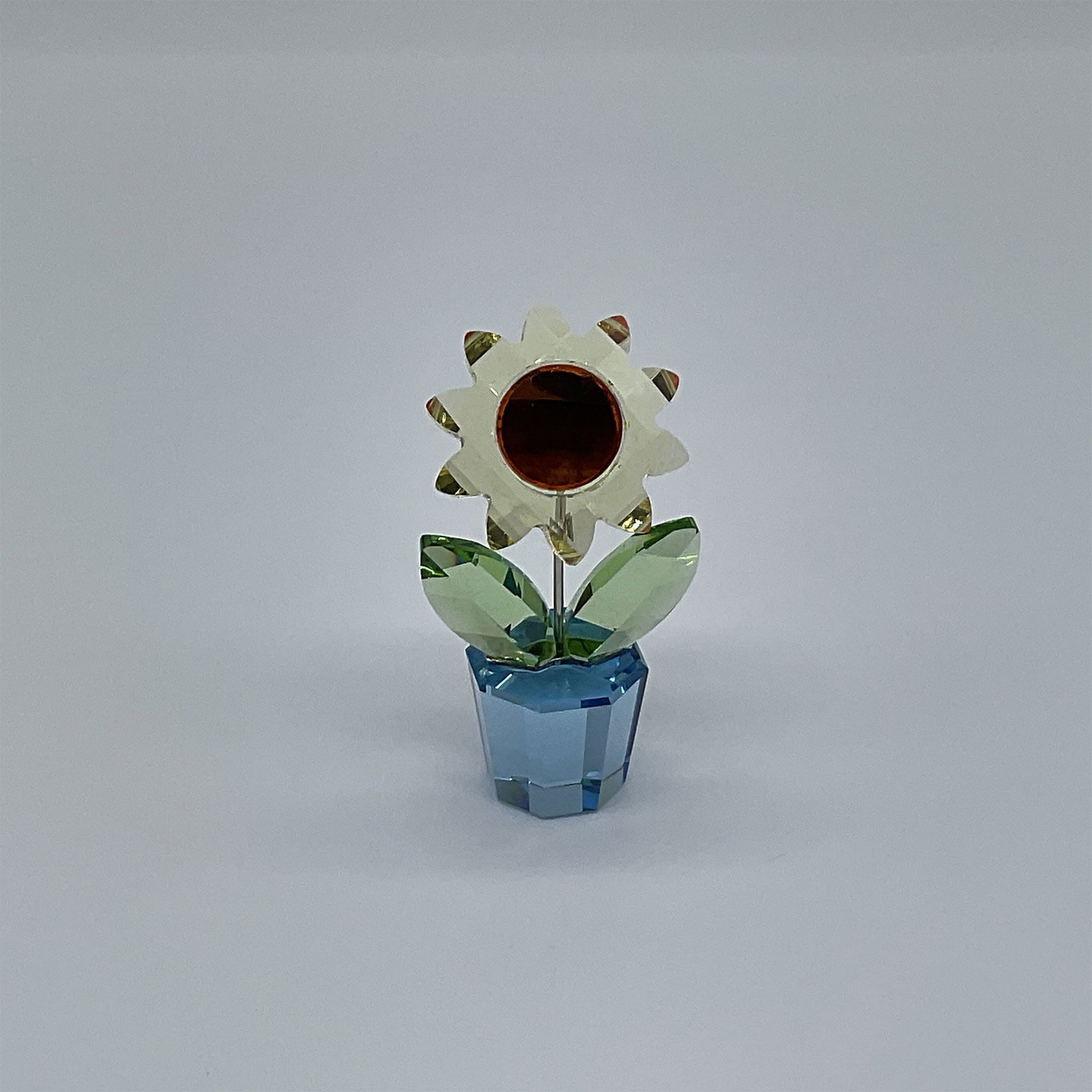 Swarovski Crystal Figurine, Sunflower Small 663148: A stunning Swarovski crystal figurine representing a delicate sunflower, expertly crafted with intricate detailing. This piece captures the essence of the flower with vibrant yellow petals and a rich 