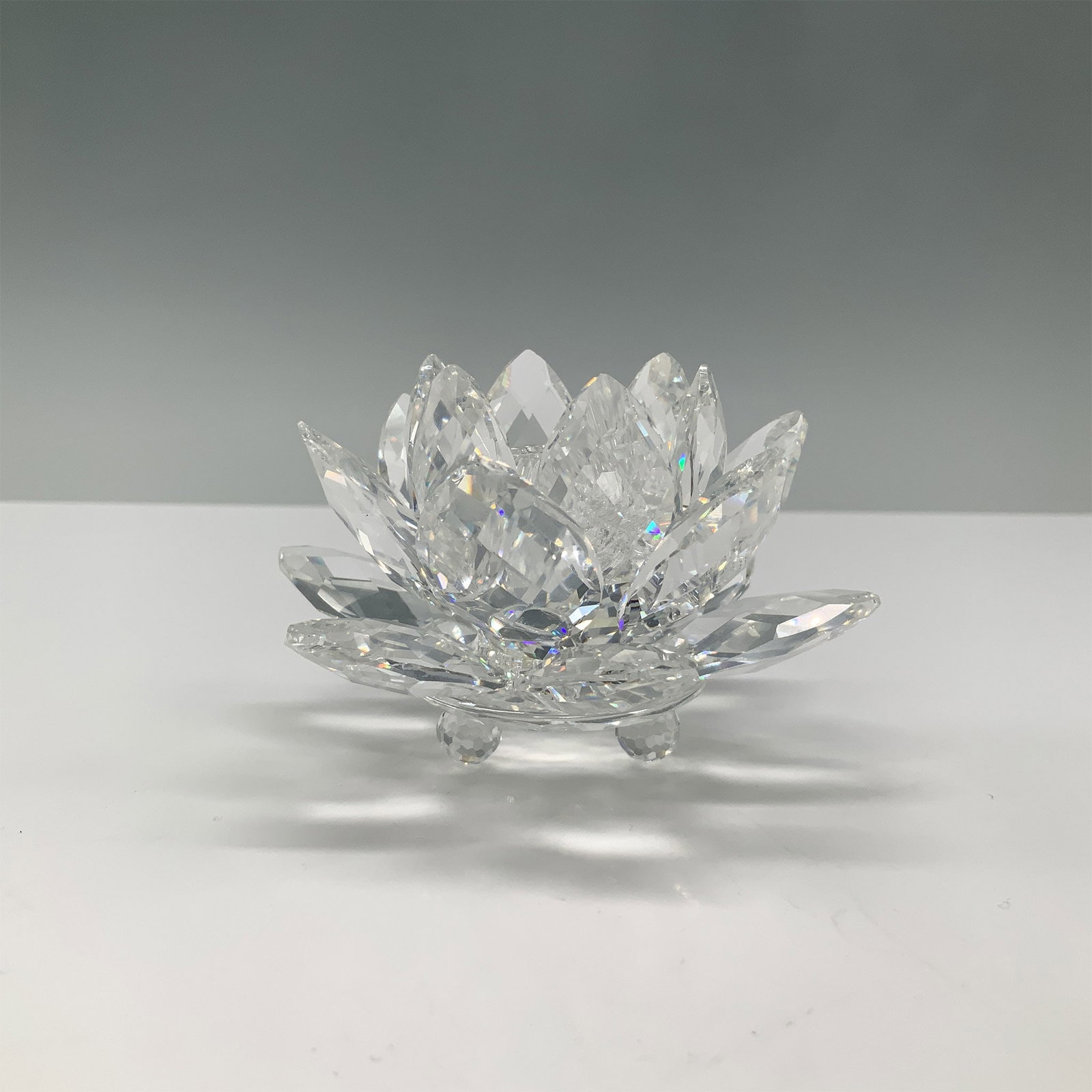 Swarovski Crystal Water Lily Candleholder with Original Box: Swarovski Crystal Water Lily candleholder, designed by Max Schreck as part of the Silver Crystal collection. This elegant piece features finely faceted petals, creating a beautiful, reflective effect.