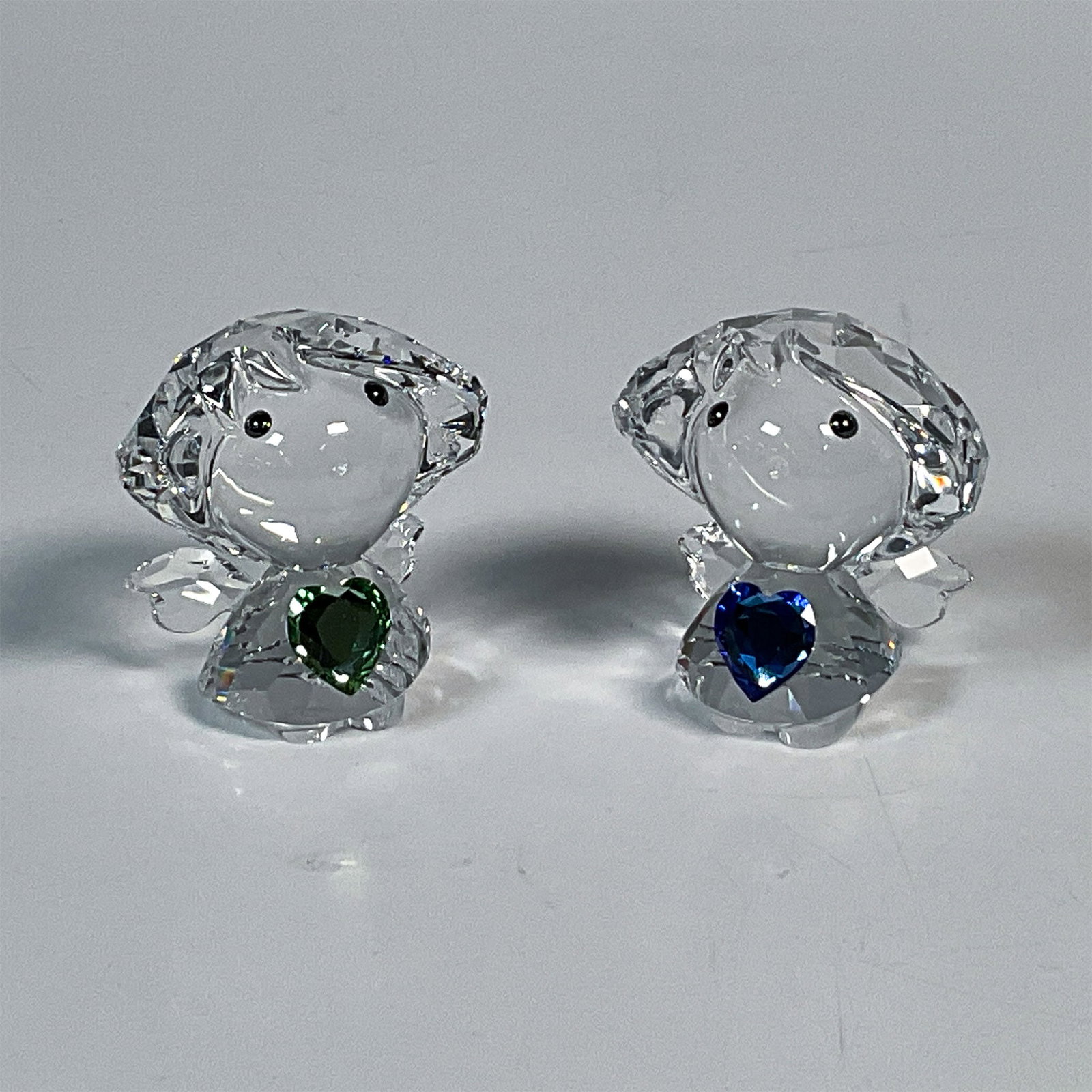 2pc Swarovski Crystal Figurines, Birthstone Angels: These adorable clear crystal angels were only available online in 2014 and in a limited quantity of 500. Here we have one angel carrying a blue crystal heart representing the birthstone for September,