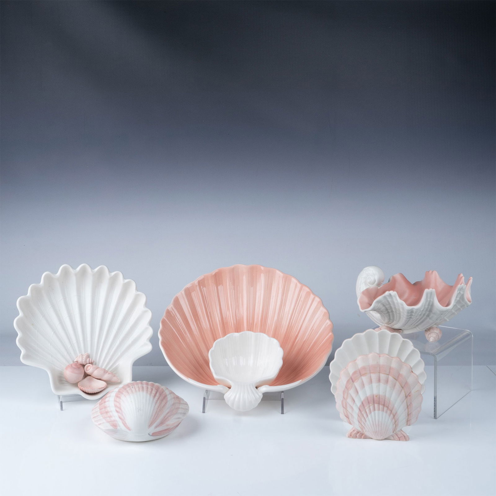 Fitz and Floyd Shell-Shaped Ceramic Serving Set: A charming five-piece Fitz and Floyd ceramic set inspired by seashell designs, featuring a soft pink and white palette. Includes the following: Large Shell Serving Bowl: A scallop-shaped bowl with an