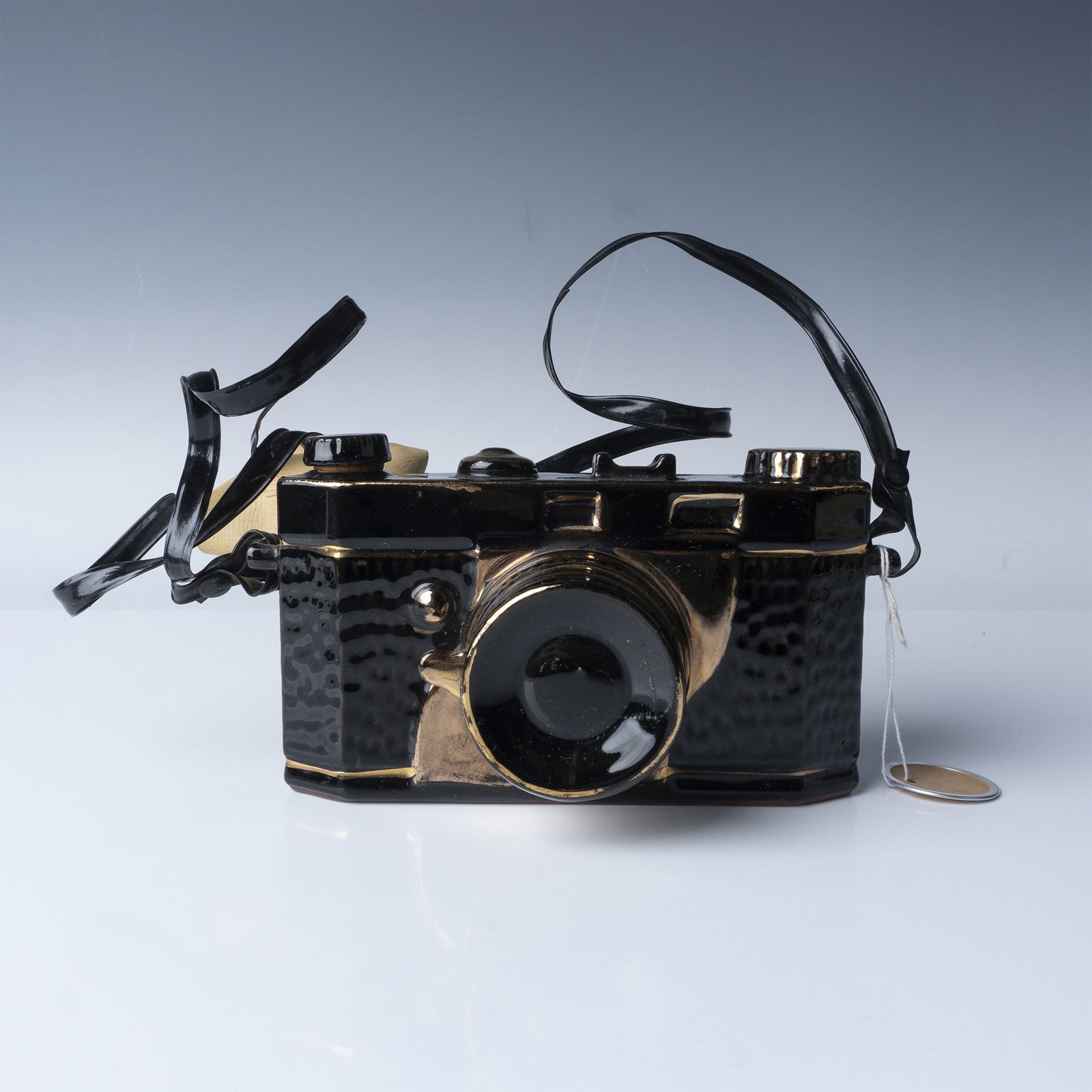 Ceramic Camera Figurine, Black with Gold Accents: Vintage ceramic figurine designed to resemble a classic film camera with intricate details. This piece features a glossy black finish accented by gold highlights, creating a striking aesthetic. Crafte