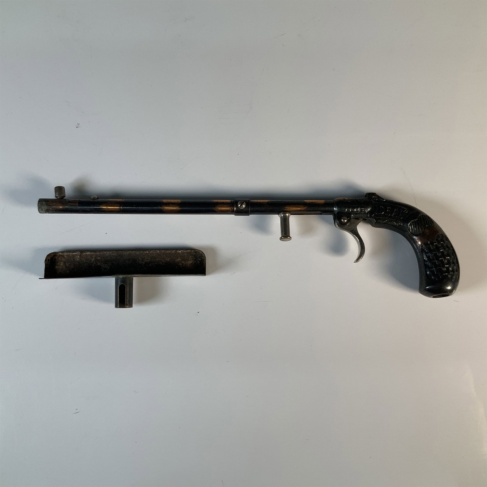 Burke & James Ideal Flash Pistol with Original Box: A vintage Burke & James Ideal Flash Gun Model No.1, is a rare early 20th-century photographer's accessory designed to create a "flash in the pan" effect for photography. This piece features a pistol-s