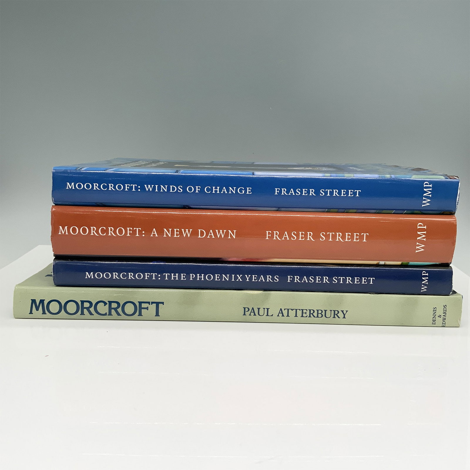 4 Moorcroft Pottery Hardcover Collector Books: Titles including: Moorcroft: A New Dawn (2006), The Phoenix Years (2000) and Wind of Change (2000) by Fraser Street. And Moorcroft Revised Edition 1897-1993 (2002) by Paul Atterbury. Dimension of larg