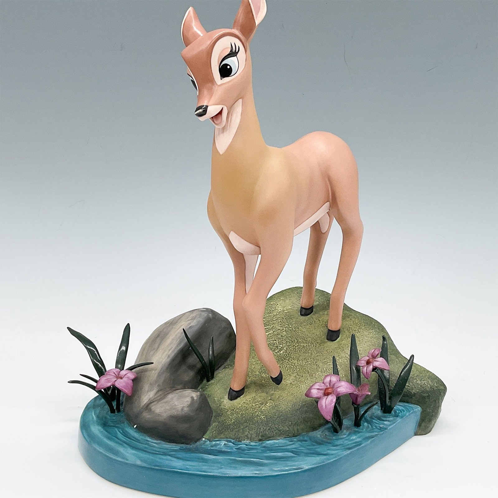 Walt Disney Classics Collection Figurine Bambi: This figurine from the Walt Disney Classics Collection features Bambi, titled "Light as a Feather," depicted gracefully standing by a stream with detailed floral and rock accents. Measuring 8"L x 8.25