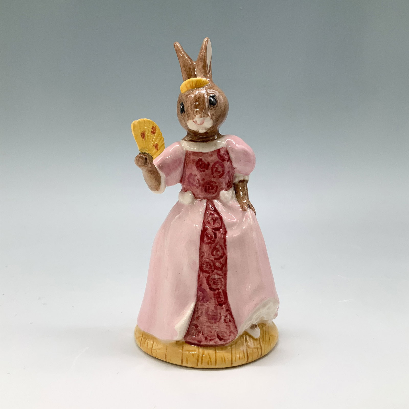 Royal Doulton Bunnykins Figurine, Cinderella DB231 w/ Box: Handmade and hand-decorated fine bone china figurine titled Cinderella Bunnykins, model number DB231. This delightful figurine features a rabbit dressed as Cinderella in a flowing pink gown with intri