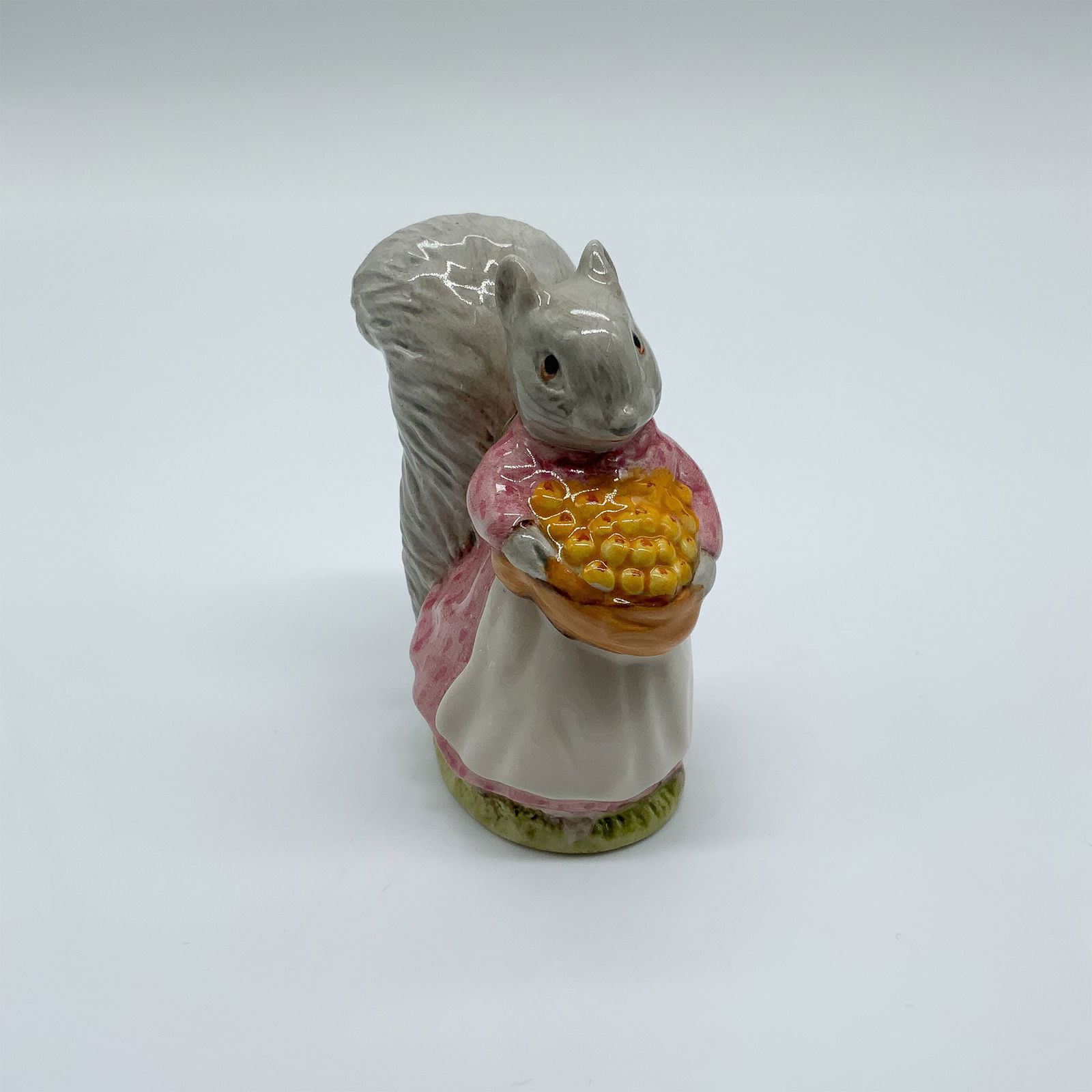 Beatrix Potter Porcelain Figurine, "Goody Tiptoes": A charming Beatrix Potter figurine depicting Goody Tiptoes, a character from Beatrix Potter's beloved tales. This finely crafted piece features meticulous detailing and vibrant hand-painted colors, ca