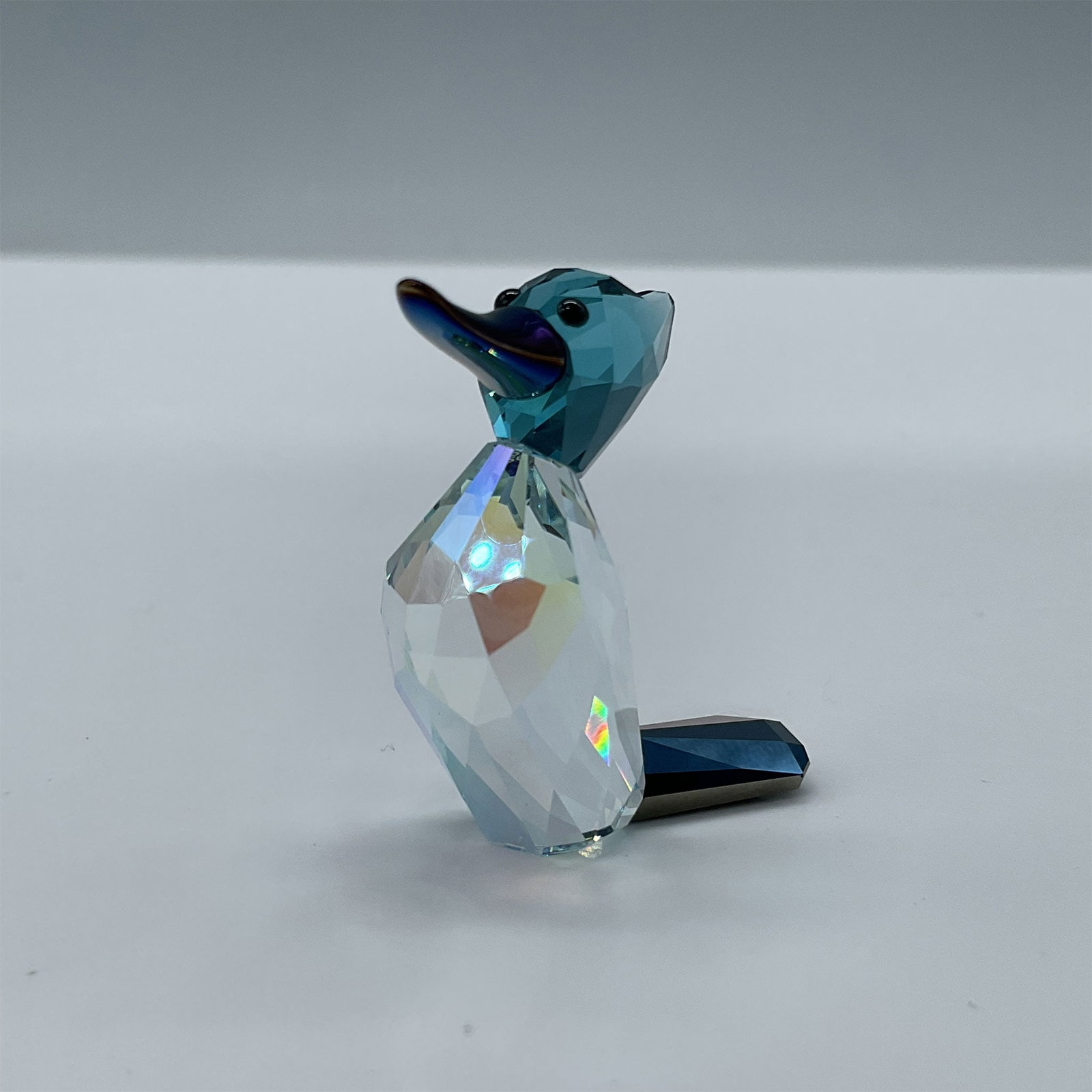 Swarovski Crystal Lovlots City Park Figurine, Ziggy: Limited edition. Features Ziggy Woodpecker with a jet metallic blue crystal beak and a light Azore Aurora Borealis facetted crystal body. Swarovski etched backstamp. This item has its original box. Bo