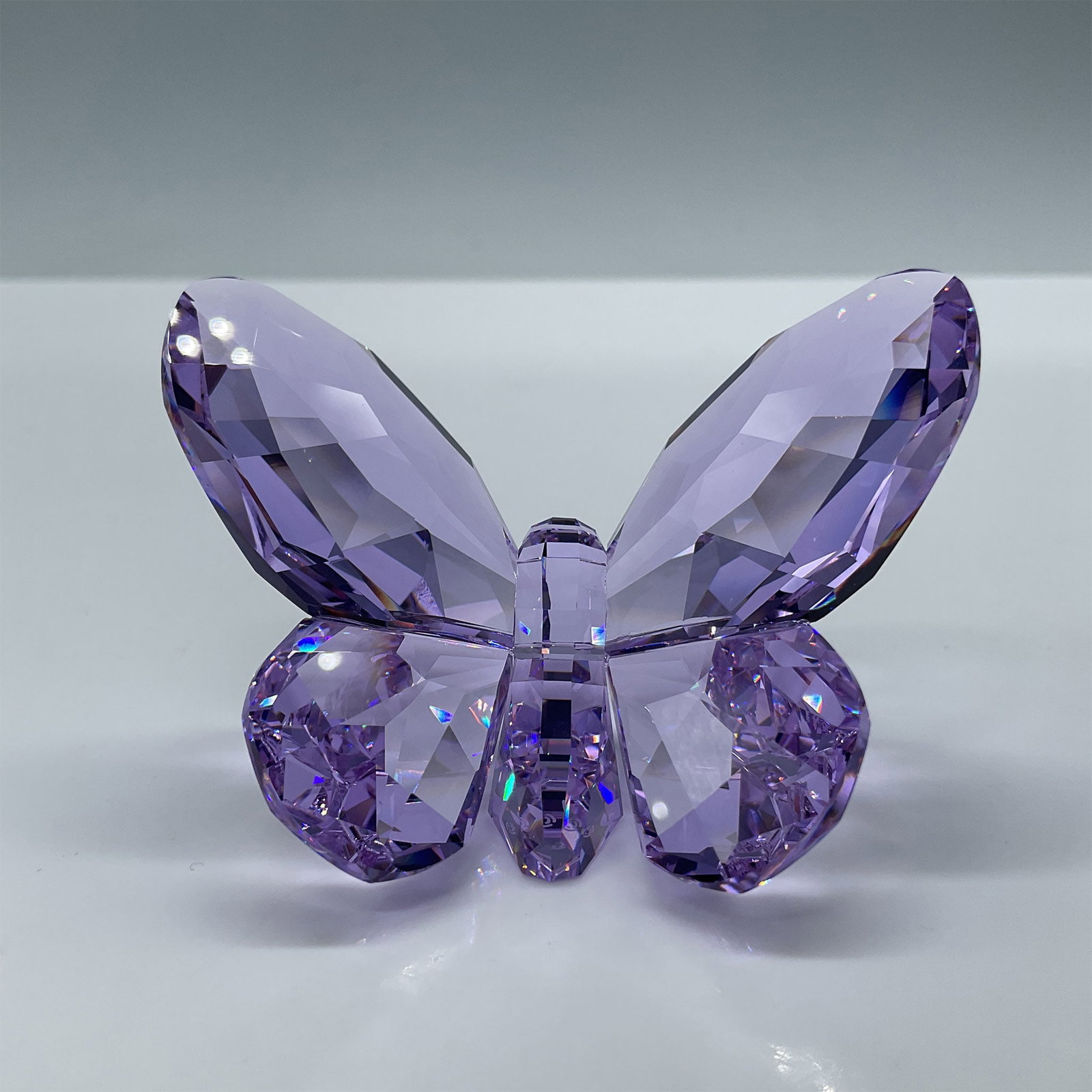Swarovski Crystal Figurine, Brilliant Butterfly - Violet: Part of the In The Secret Garden and Crystal Moments collections. A beautiful light purple faceted crystal butterfly. Swarovski etched backstamp. This item has its original box. Box measures: 2.75''L 