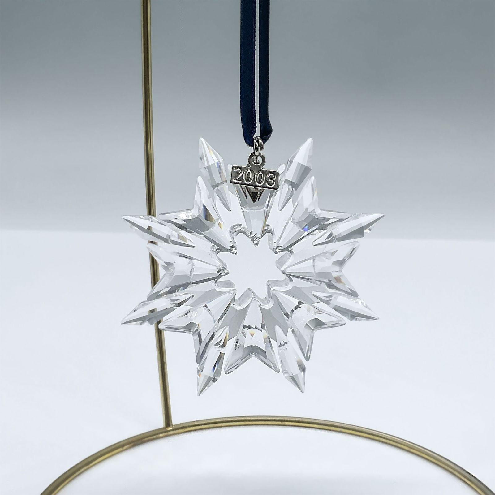 Swarovski Crystal Figurine, 2003 Christmas Ornament: This lovely ornament has 8 points and a metal tag with 2003 etched on it. Swarovski engraving. 622498. Artist: Martin Zendron Issued: 2003 Dimensions: 2.75"W x 2.75"H Country of Origin: Austria