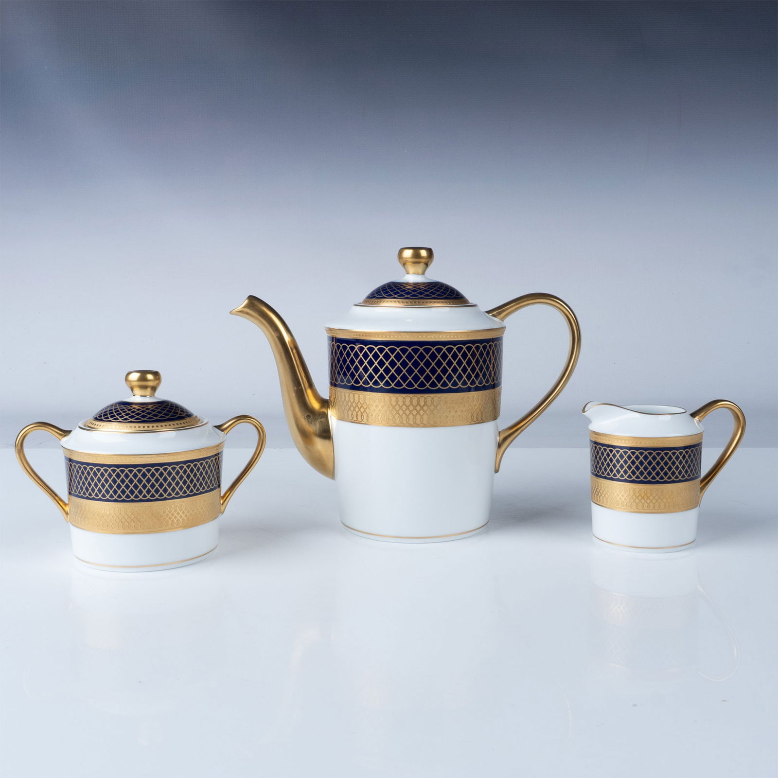 3pc Bernardaud Limoges Coffee/Tea Set, Vintimille: This luxurious 3-piece coffee or tea set by Bernardaud is a refined addition to any table setting. The set includes a coffee or tea pot, creamer, and lidded sugar bowl, all adorned with intricate gold