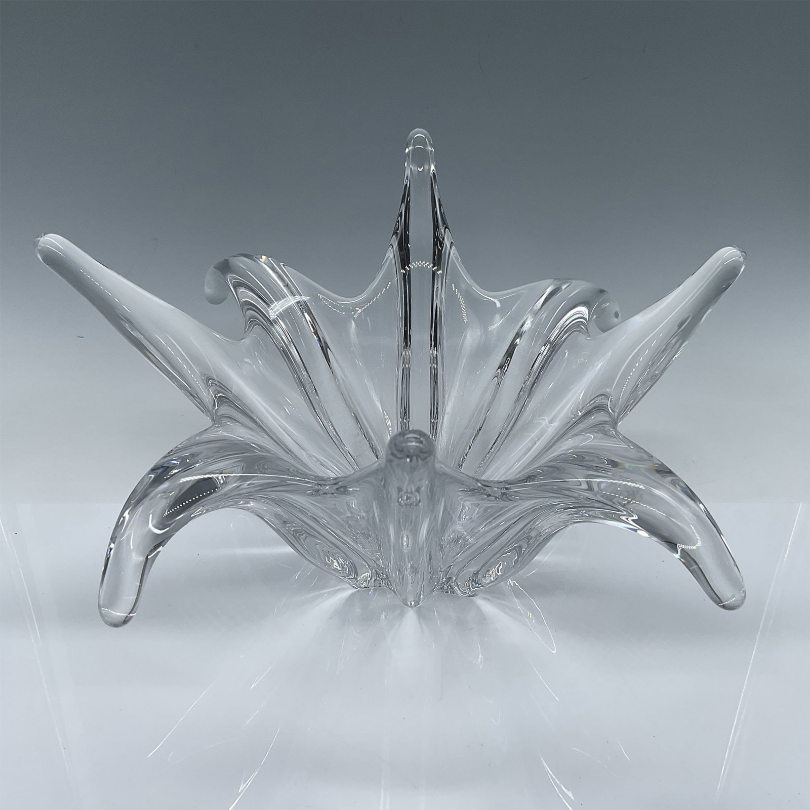 Baccarat Crystal Bowl, Octopus Design: This exquisite Baccarat crystal bowl features a captivating starburst design with elegant, flared and sculpted points, evoking a sense of fluidity and motion. Measuring 13"L x 11.25"W x 6.5"H, the bow