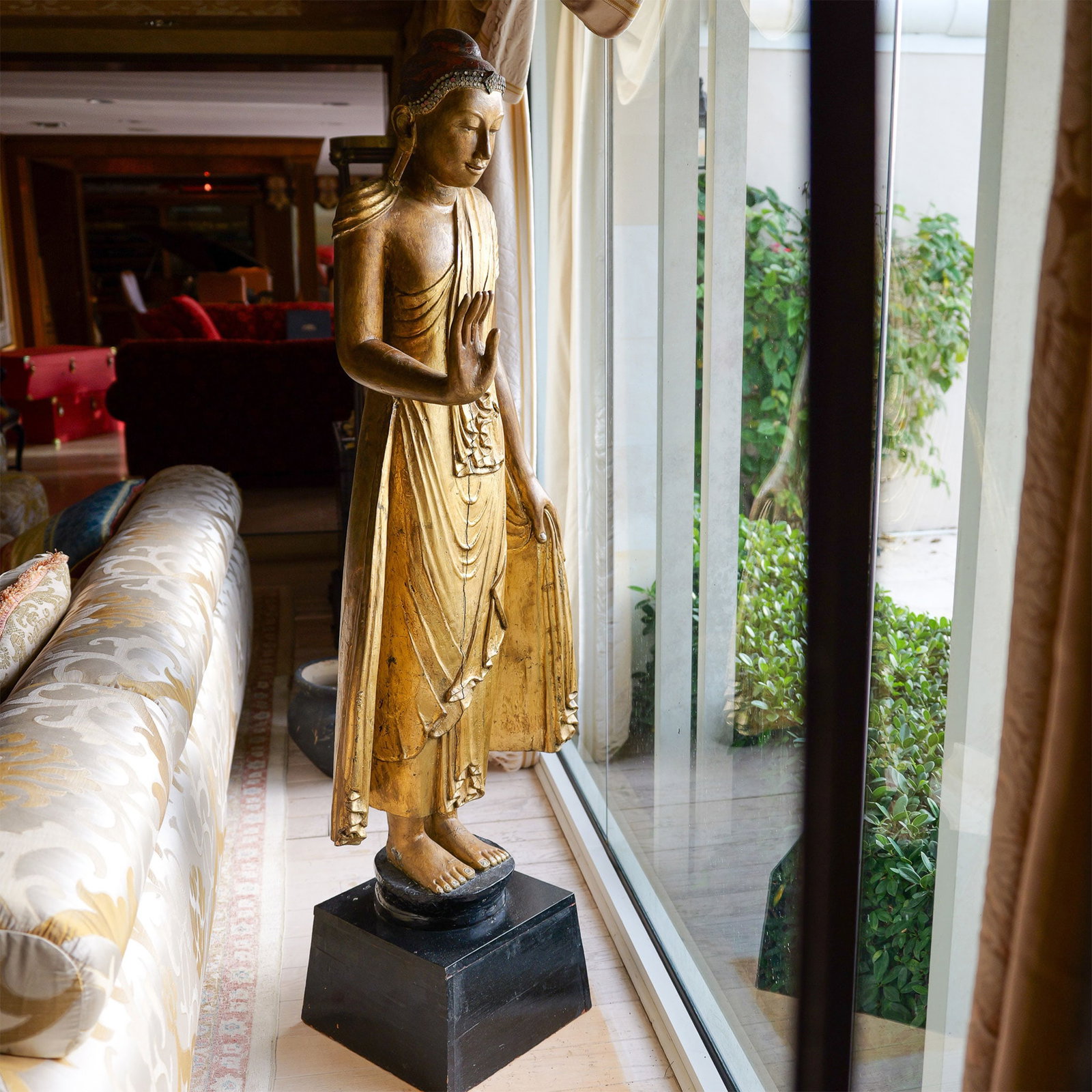 Burmese Giltwood Figure of Mandalay Buddha: This exceptional Burmese Giltwood Standing Figure of Mandalay Buddha is a testament to the artistry and spiritual devotion. Elegantly carved from wood and adorned with gilding, the figure exudes both 