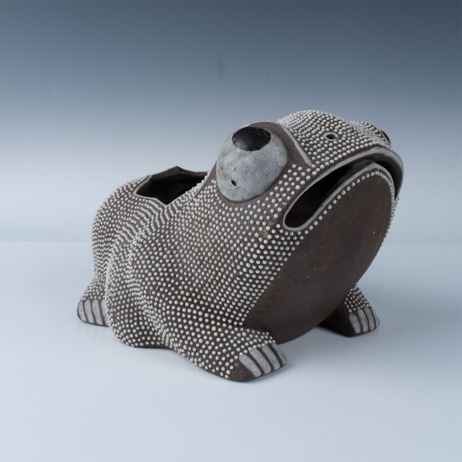 Moulded ceramic 'CROUCHED FROG' ceramic, China, Qing Dynasty: This charming antique toad or frog vase features a textured design with intricate white dot detailing across the dark brown surface, resembling a natural skin pattern. The piece is artistically sculpt