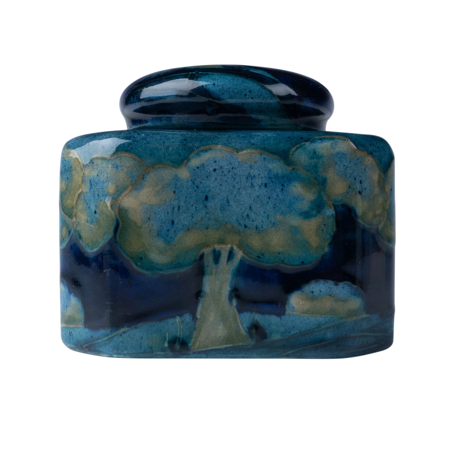 William Moorcroft Covered Inkwell, Moonlit Blue: A Moorcroft pottery inkwell crafted in the iconic Moonlit Blue pattern, featuring serene depictions of trees against a deep blue background. The piece includes a matching lid adorned with the same sce