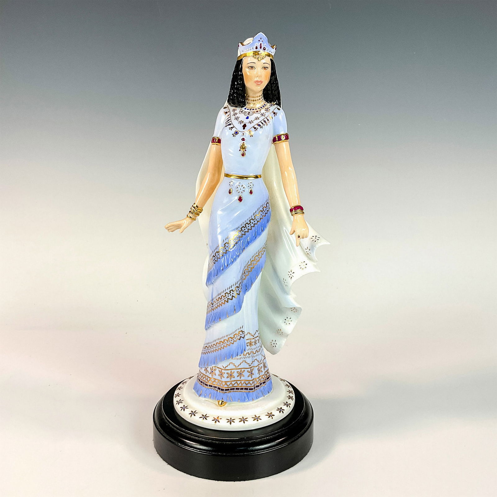 Coalport Bone China Figurine, Queen of Sheba: Limited edition figurine modeled as the beautiful Queen of Sheba wearing a tiered cornflower blue dress with gilded gold and burgundy details. Coalport backstamp. Certificate of Authenticity included.