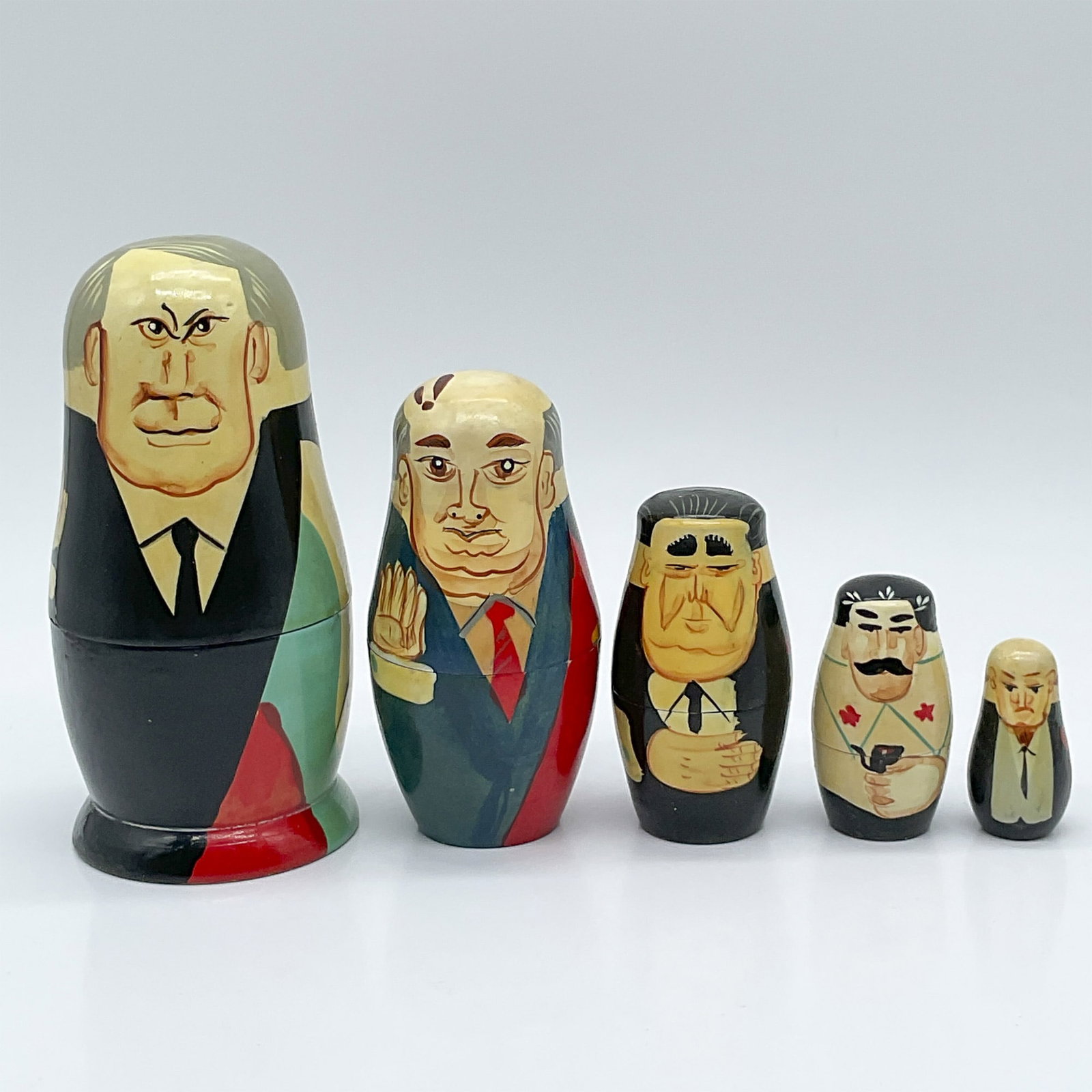 Vintage Russian Leaders Nesting Dolls: Features a nesting doll with 5 pieces depicting different Russian political leaders. Issued: 20th century Dimensions: 5.5"H