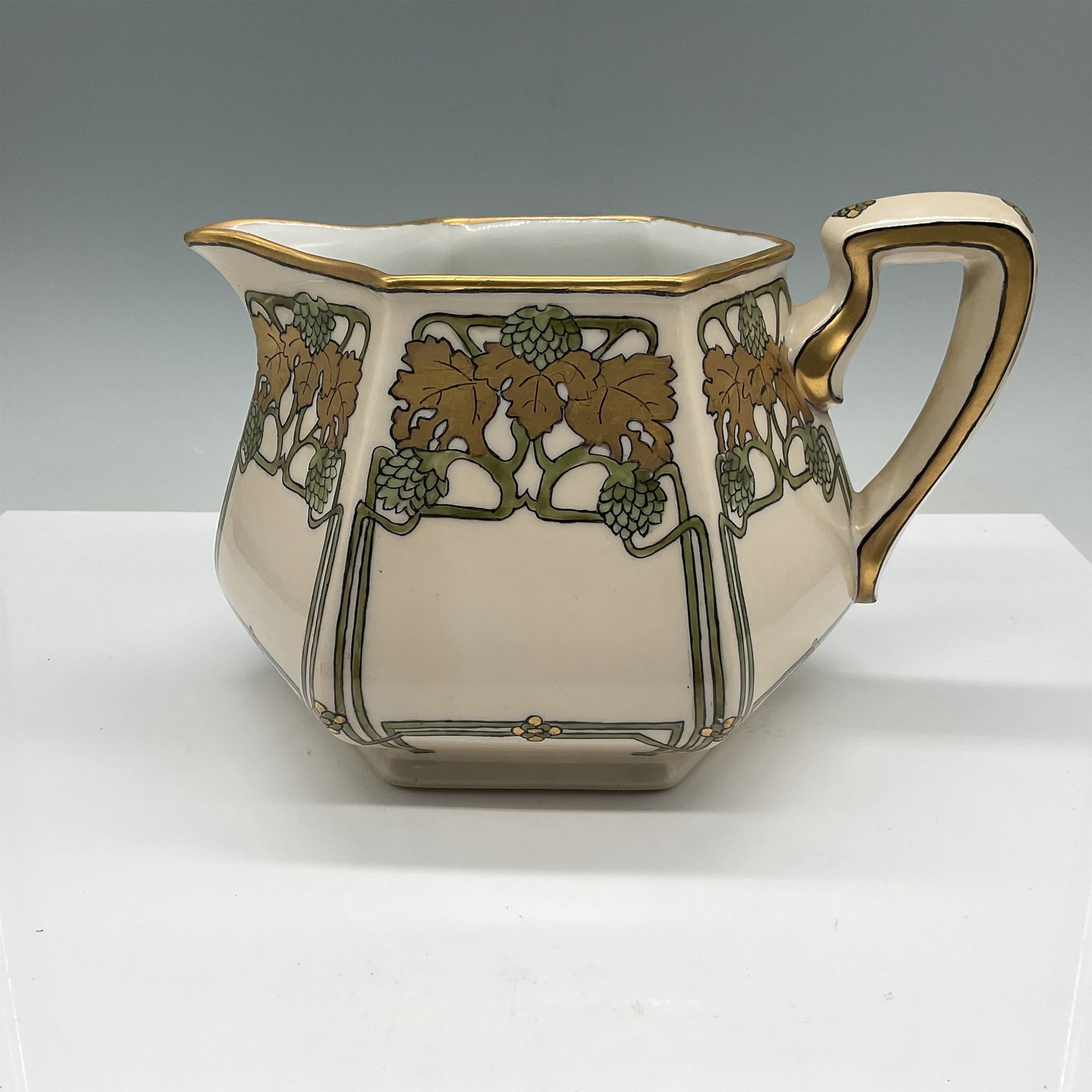 Bernardaud & Co. (B&C) Art Nouveau Pitcher with Grape Motif: This elegant ceramic pitcher was crafted by Bernardaud & Co. (B&C), a prominent porcelain manufacturer from Limoges, France, renowned for its exceptional quality and artistry since the late 19th centu