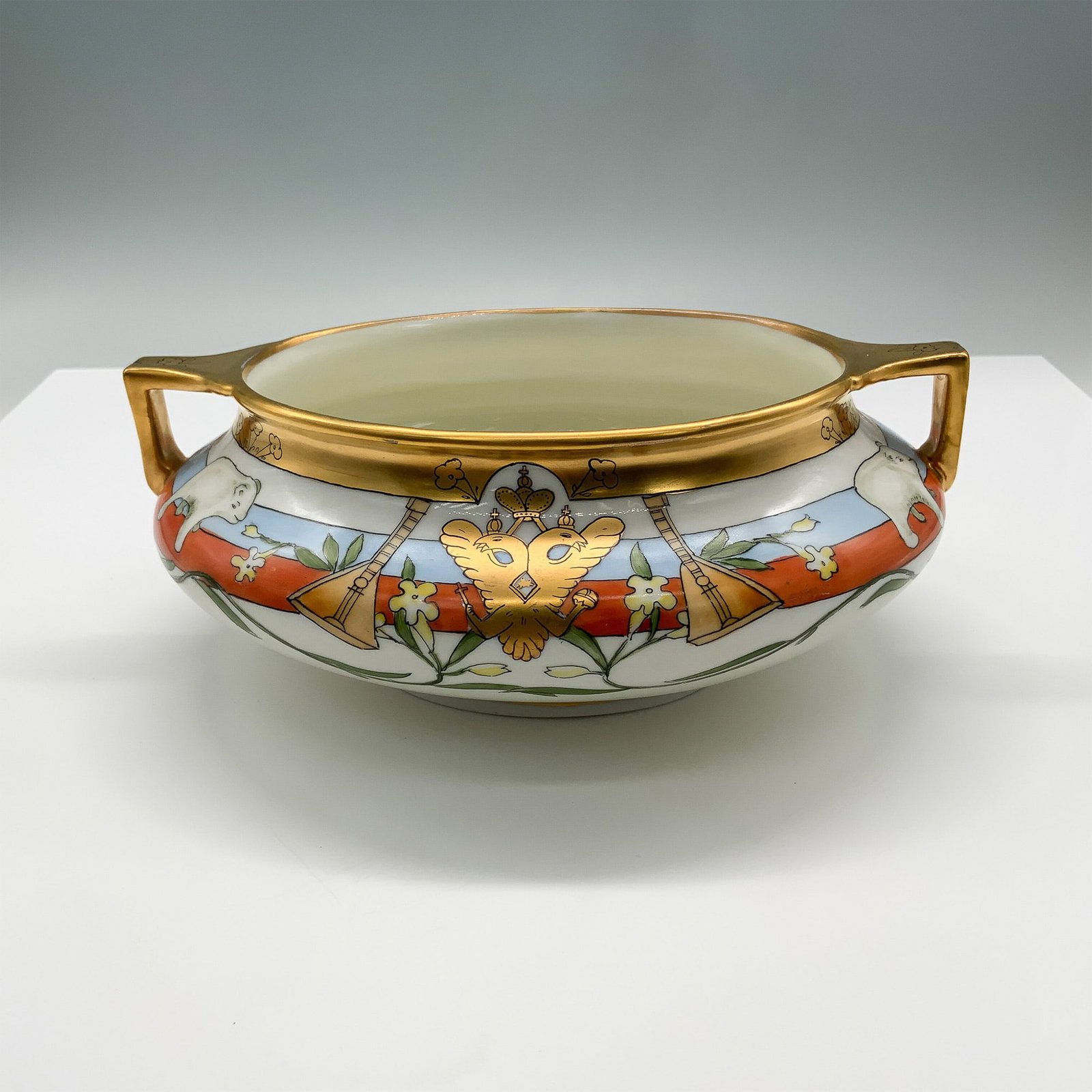 Pickard Hand-Painted Porcelain Bowl, Russian Imperial Motif: Elegant hand-painted Pickard porcelain bowl featuring a striking Russian imperial motif. The design showcases a double-headed eagle emblem, musical instruments, and delicate floral elements, all highl