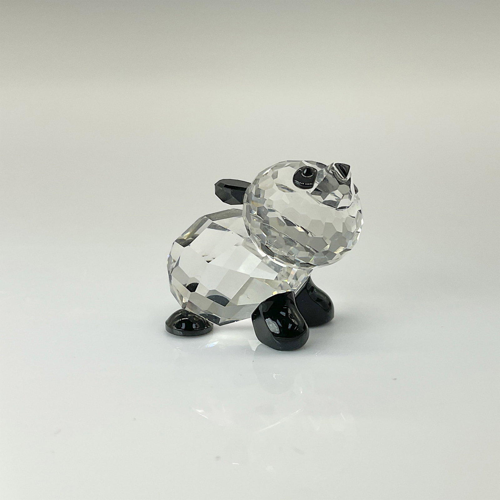 Swarovski Crystal Figurine, Miniature Baby Panda 181081: Part of the Endangered Species collection, this lead crystal panda cub features jet black crystal eyes, ears, and limbs for a charming and lifelike design. Swarovski etched backstamp. This item has it