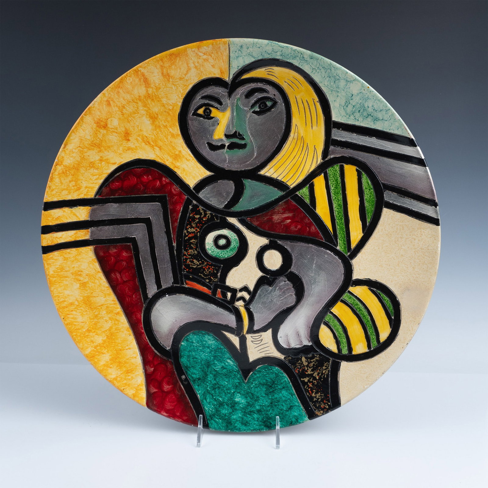 Alexander Kalifano Postmodern Carved Ceramic Face Charger: Hand painted baluster charger created with textural carvings and finished in vibrant colors of yellow, green, red and black. Kalifano mark on reverse. Artist: Alexander Kalifano Issued: 20th century D