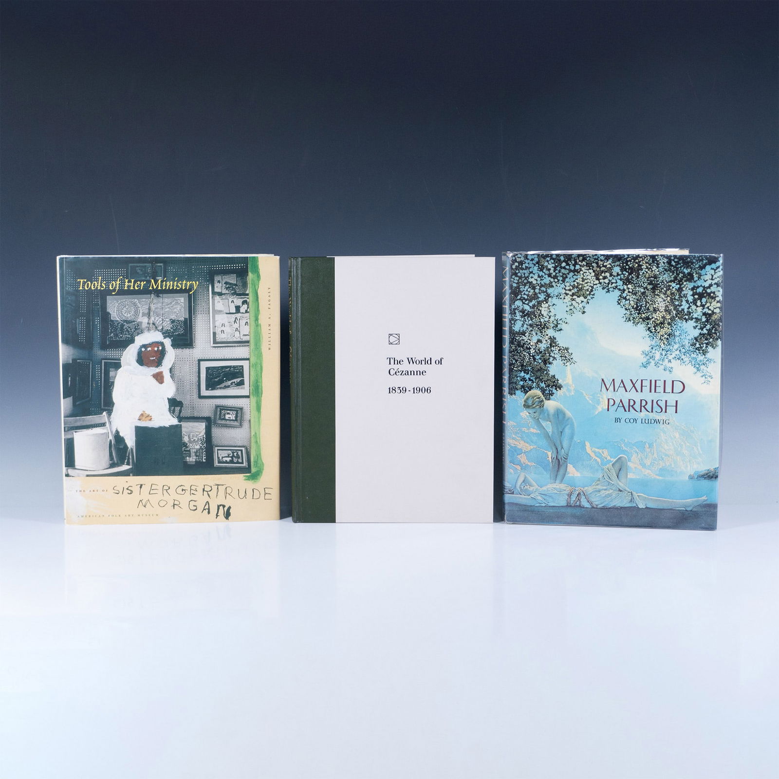 3pc Art Book Collection, Hardcover: A diverse collection of art books that include Maxfield Parrish by Coy Ludwig, Tools of Her Ministry: The Art of Sister Gertrude Morgan by William Fagaly, and The World of Cezanne 1839-1906 in a slipc