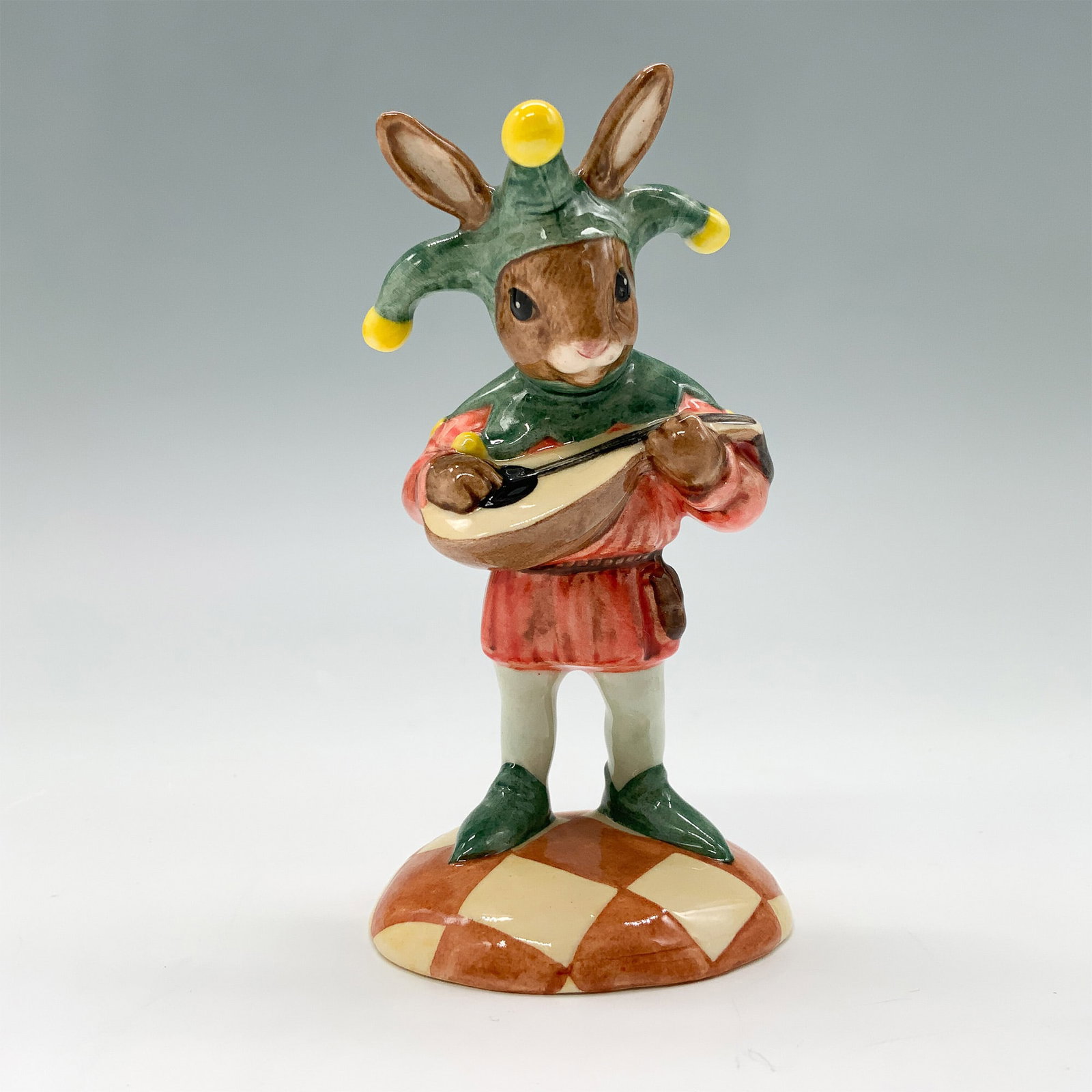 Royal Doulton Bunnykins Figurine, Jester DB161 w/ Box & COA: This delightful Royal Doulton Bunnykins figurine, titled Jester, was issued in 1995 as part of a limited edition of 1,500 pieces. It depicts a playful bunny dressed in a colorful jester outfit, comple