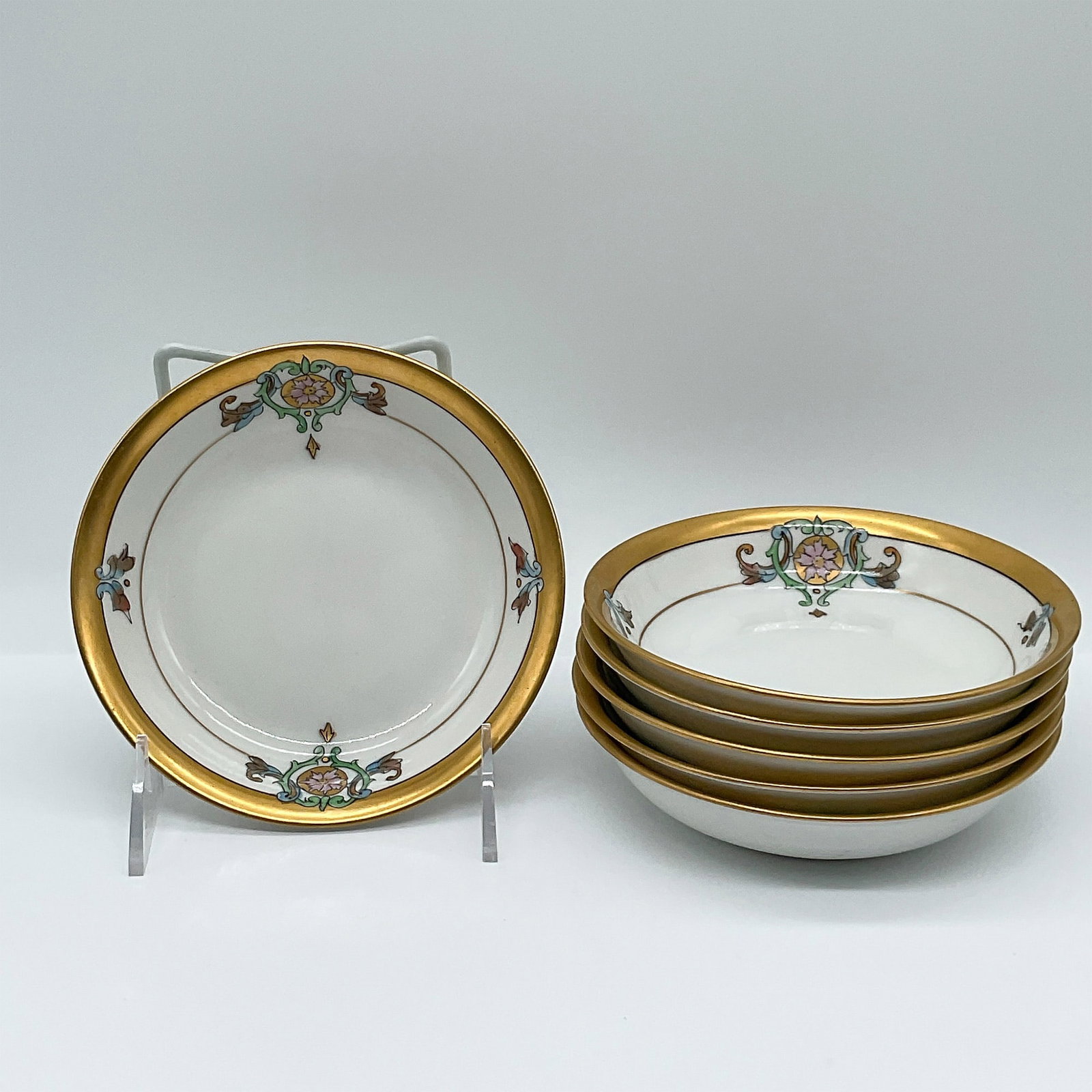 Pickard Porcelain Bowls, Hand-Painted with Gilded Rim: Set of six finely crafted Pickard porcelain bowls, each measuring 5.25 inches in diameter. Featuring an elegant hand-painted floral motif with pastel blue and pink detailing, these bowls are adorned w